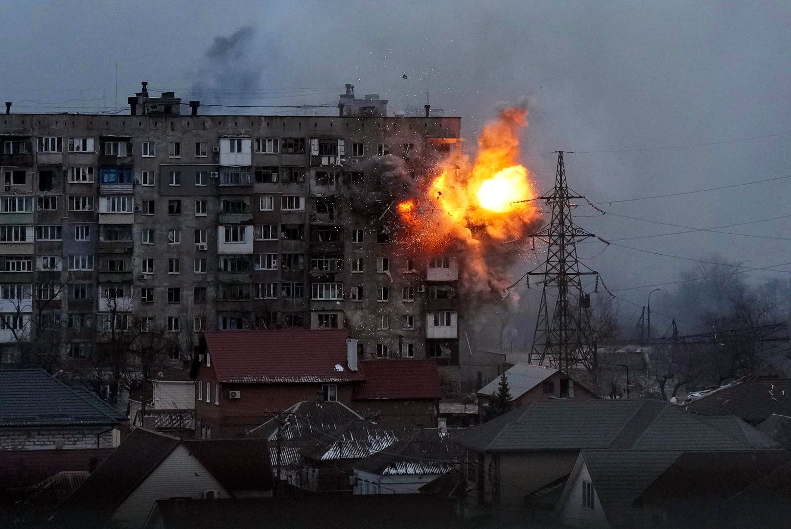 An explosion is seen in an apartment building after Russian's army tank fires in Mariupol