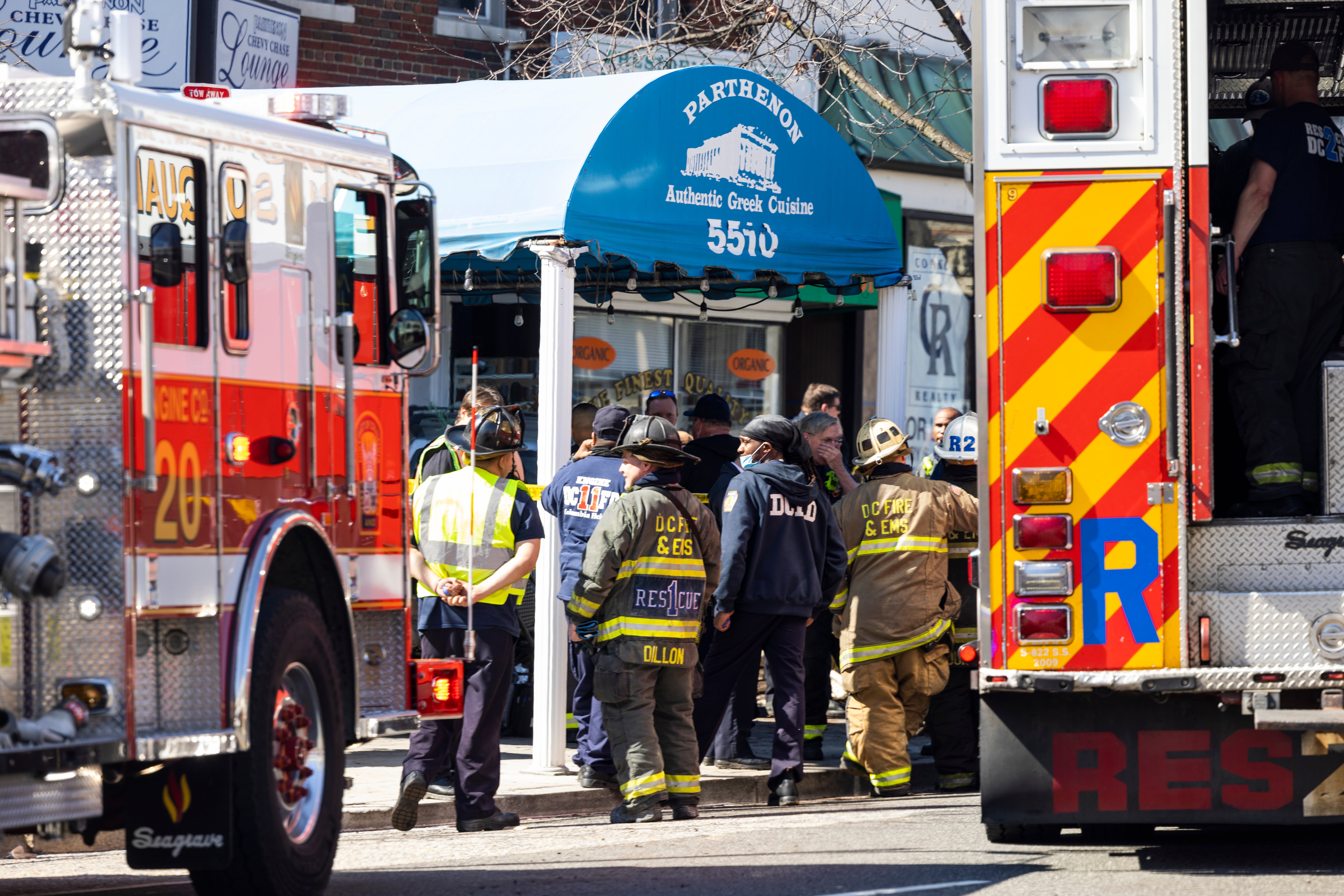 Emergency personal surround a vehicle that crashed into diners who were eating at the Parthenon Restaurant remains on the sidewalk in the Chevy Chase neighborhood of Washington, DC, USA, 11 March 2022