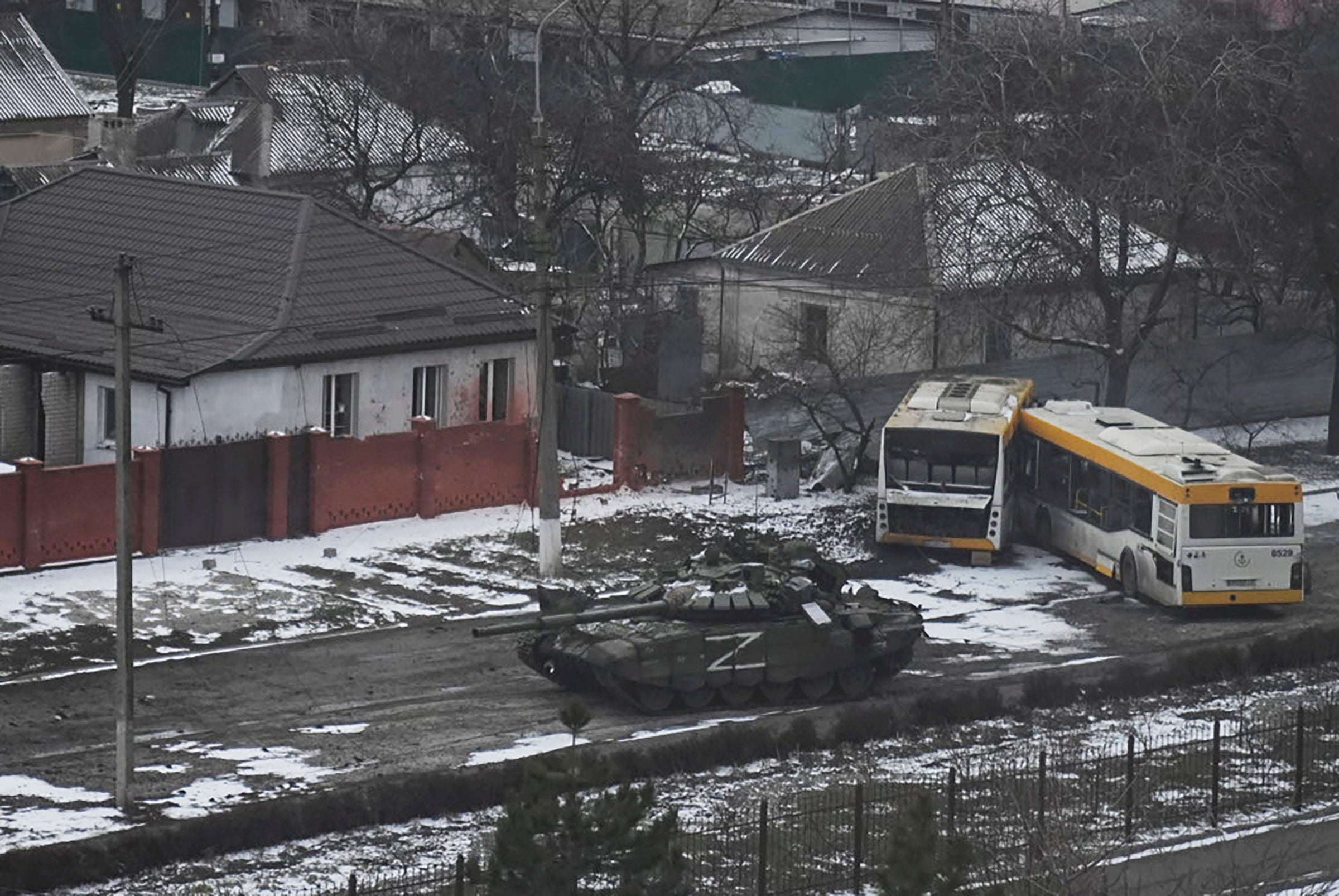 A Russian army tank moves through a street on the outskirts of Mariupol, Ukraine, Friday, March 11, 2022