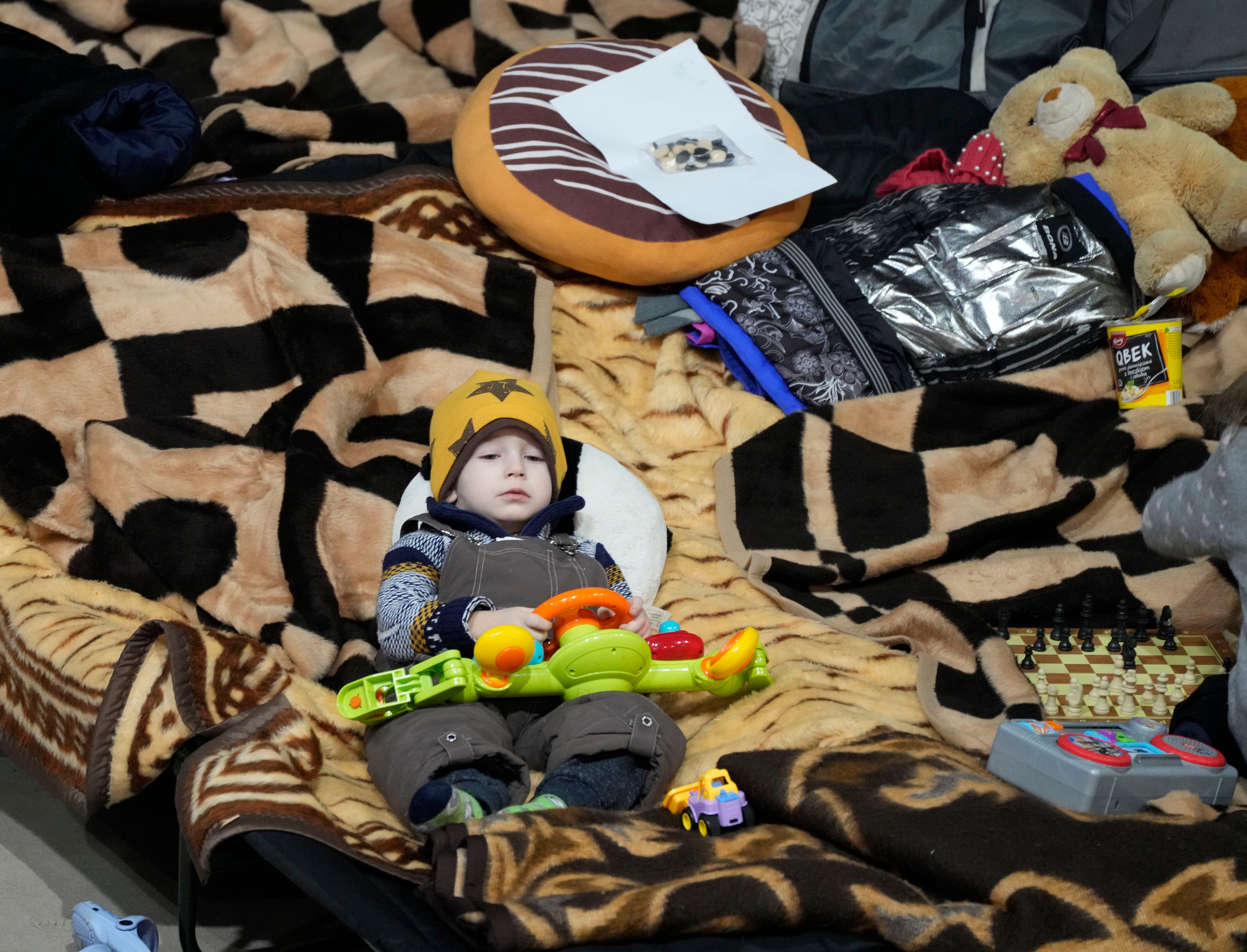 A boy holds a toy as he rests in a centre for Ukrainian refugees in Warsaw, Poland (Czarek Sokolowski/AP)