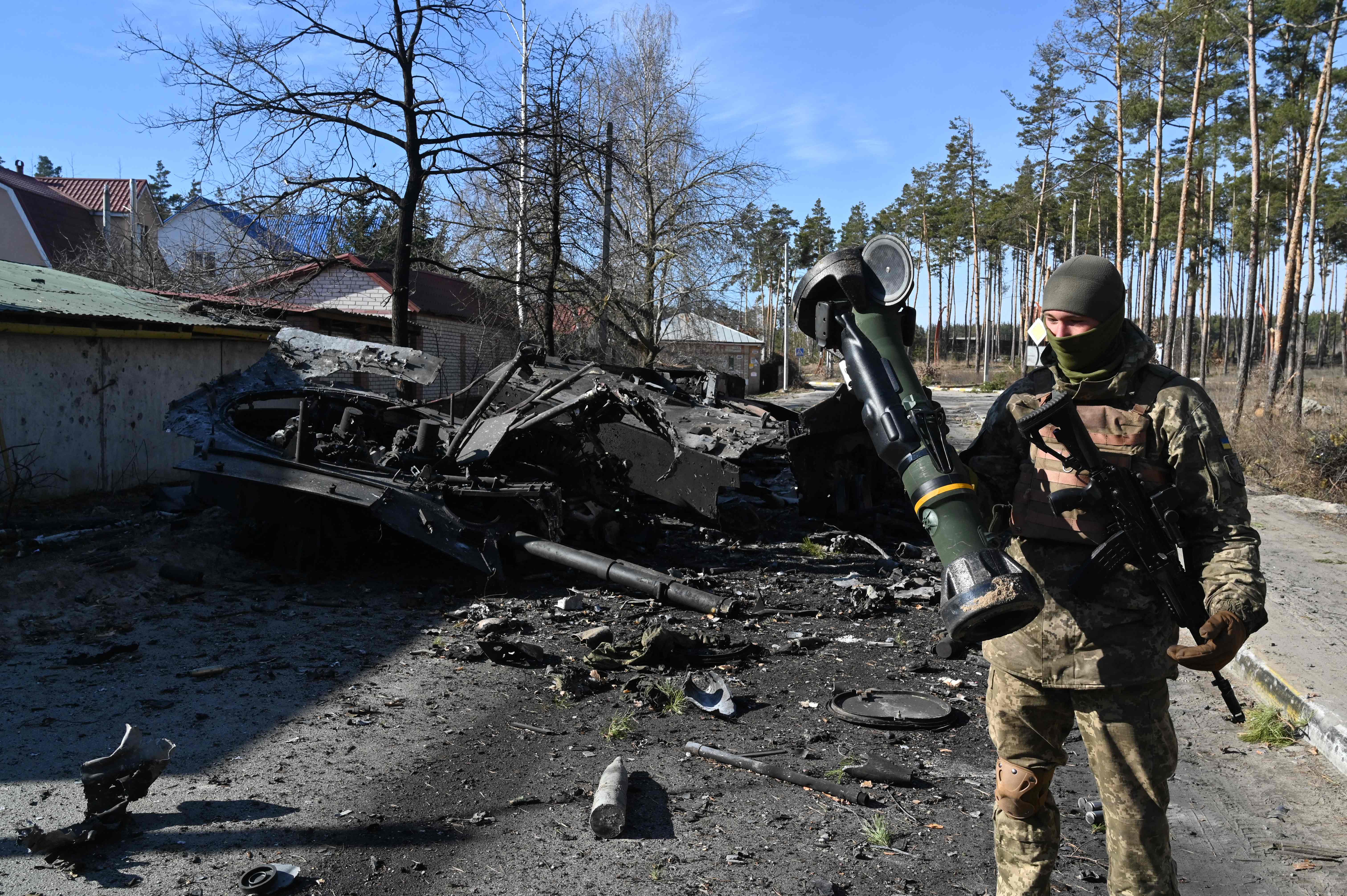 A Ukrainian soldier holds a next generation light anti-tank weapon (N-LAW) that was used to destroy a Russian armoured personal carrier in Irpin, north of Kyiv