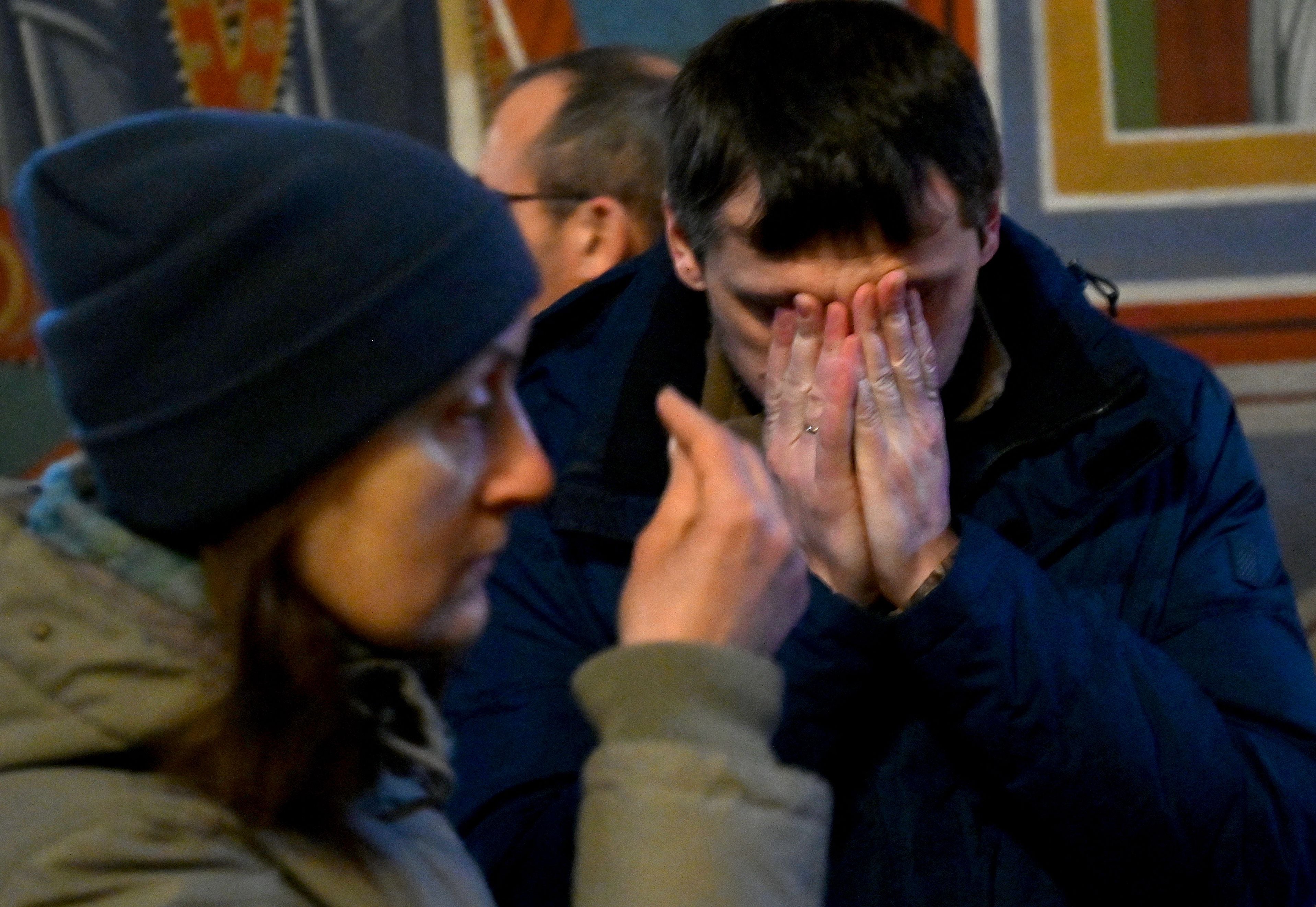 A man reacts as he prays at the Mykhailo Golden-Domes Cathedral in Kyiv