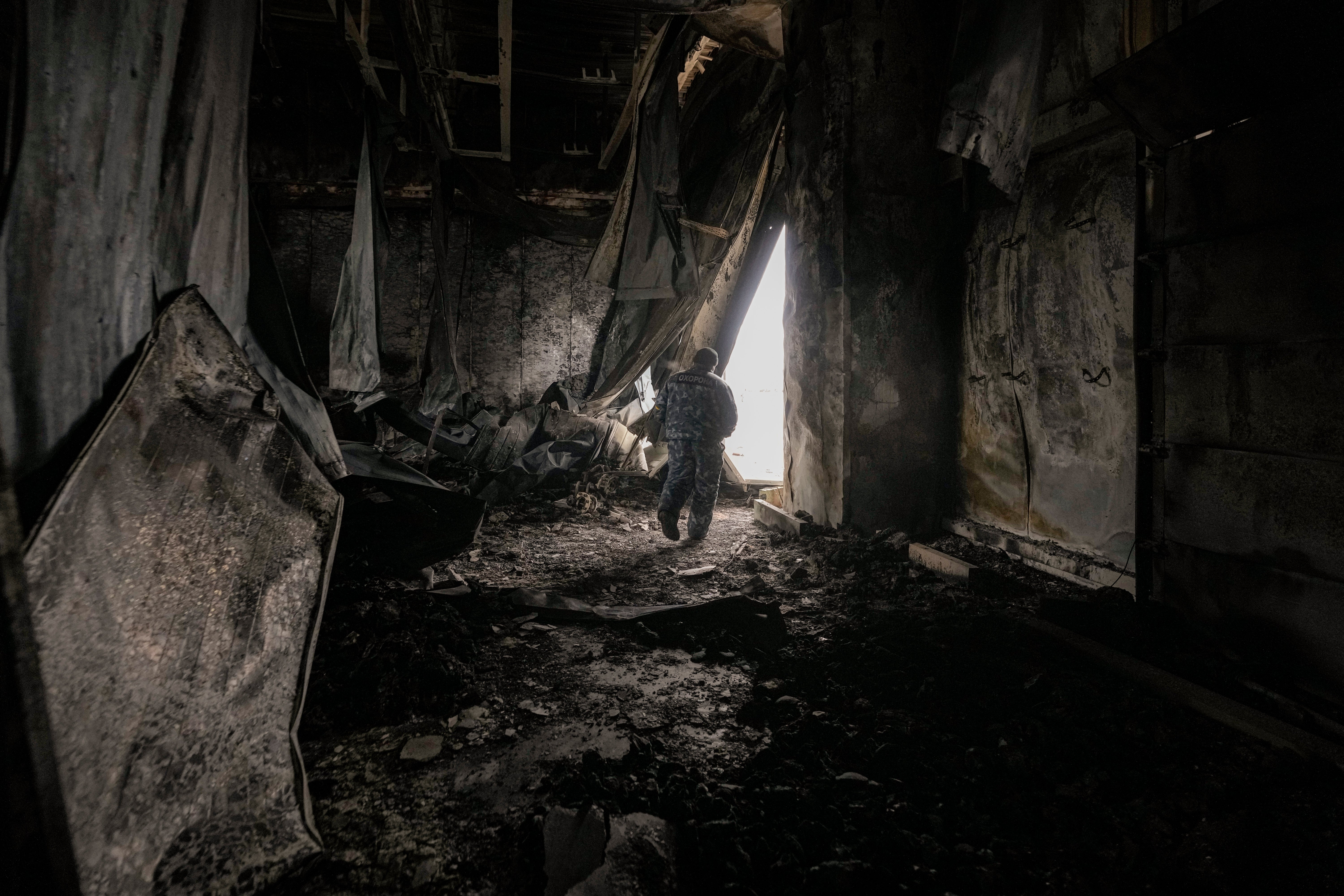 A staff member exits a large food products storage facility which was destroyed by an airstrike in the early morning hours in Brovary, north of Kyiv