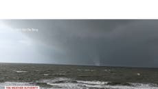 Beachgoers run for cover as waterspout turns into tornado in Florida