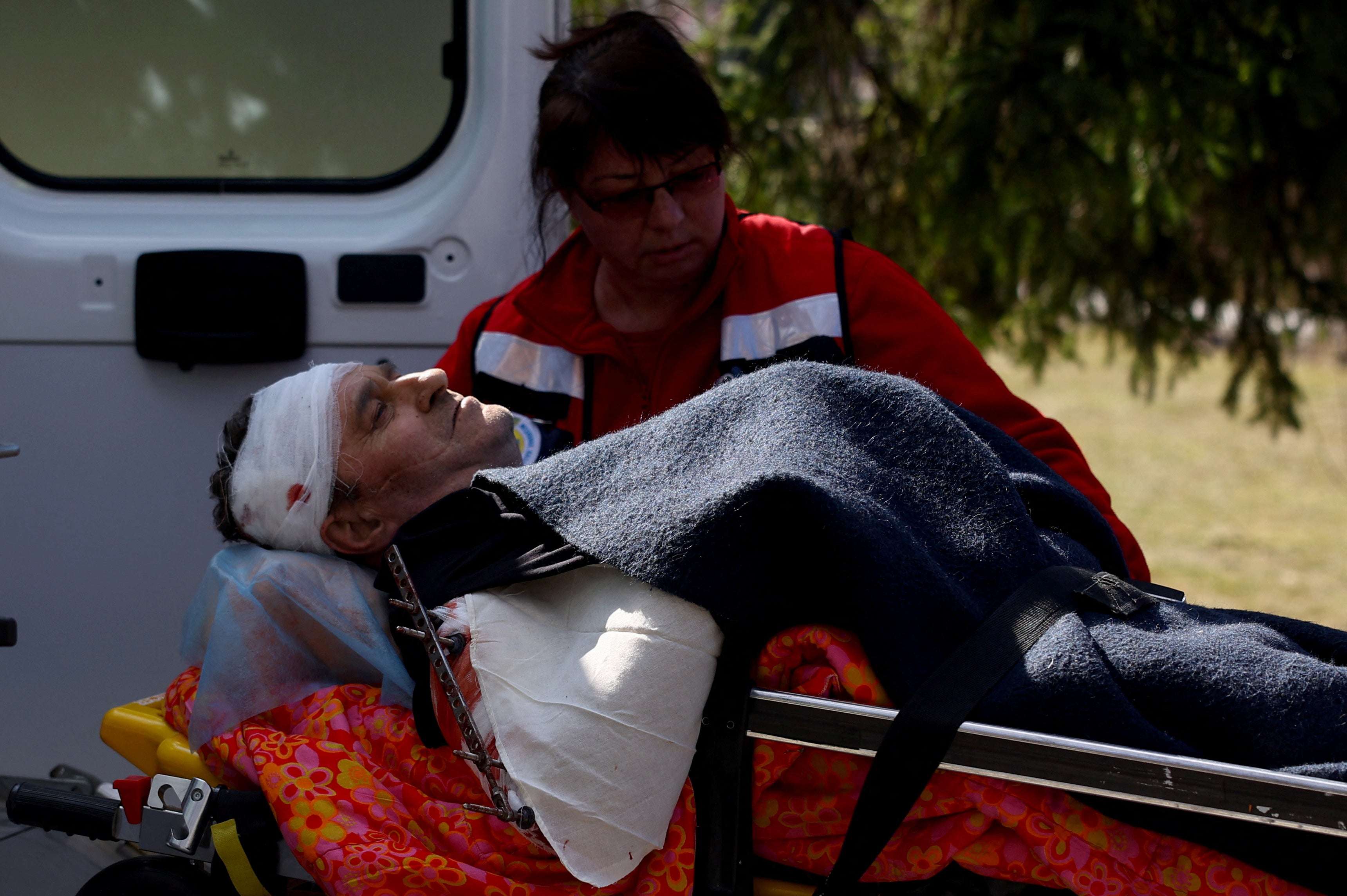 A medic transports a serviceman on a stretcher after Sunday’s missile strike