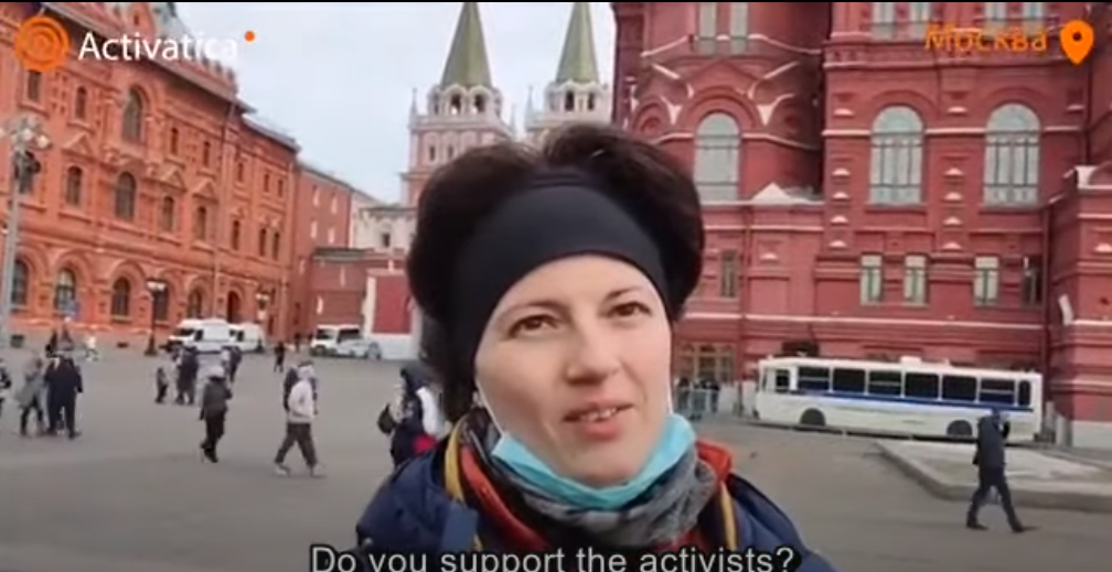 Police led this young woman away just seconds after she held up a paper sign