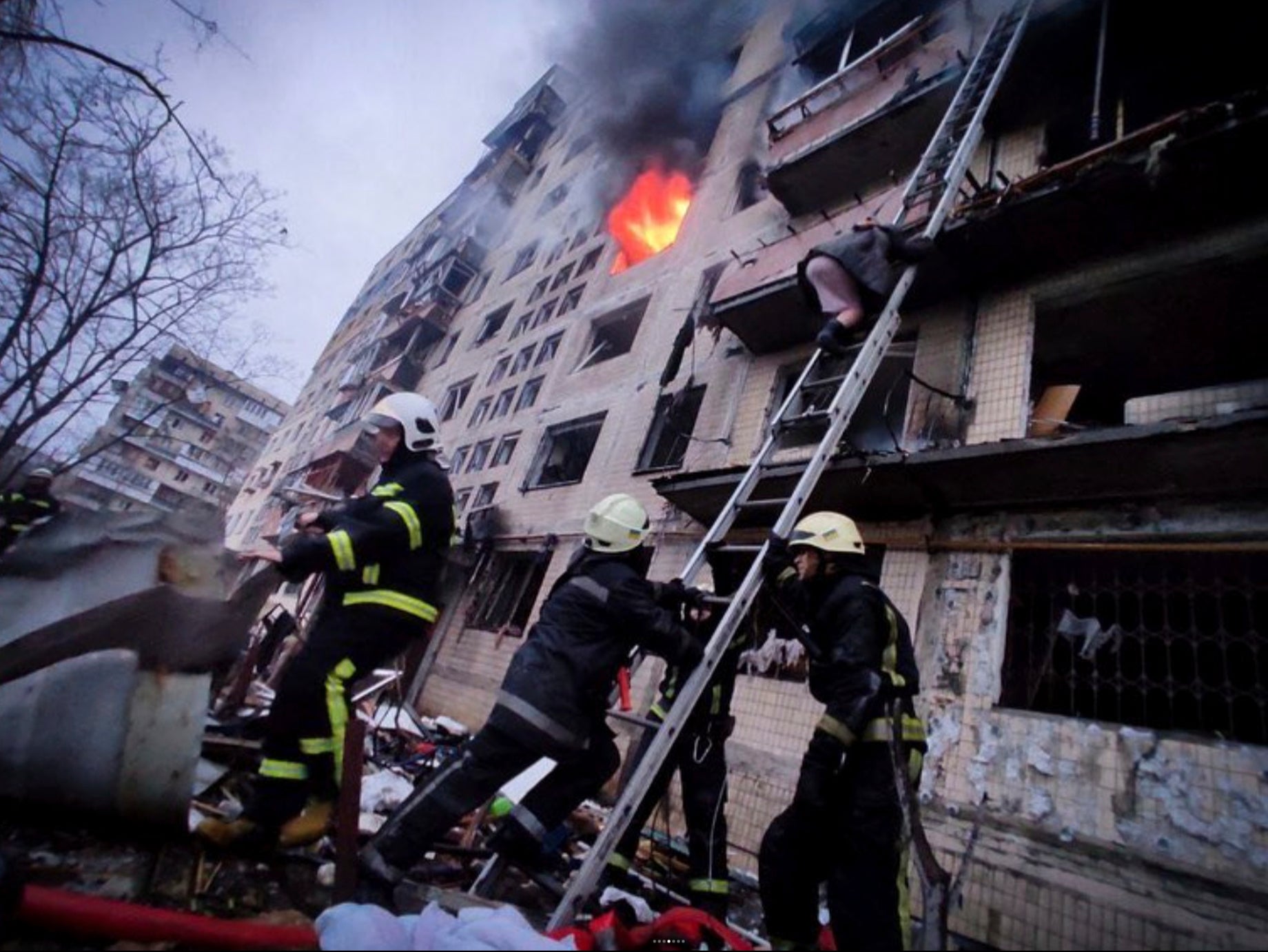 Firefighters continue to fight to put out the blaze after an airstrike in Kyiv