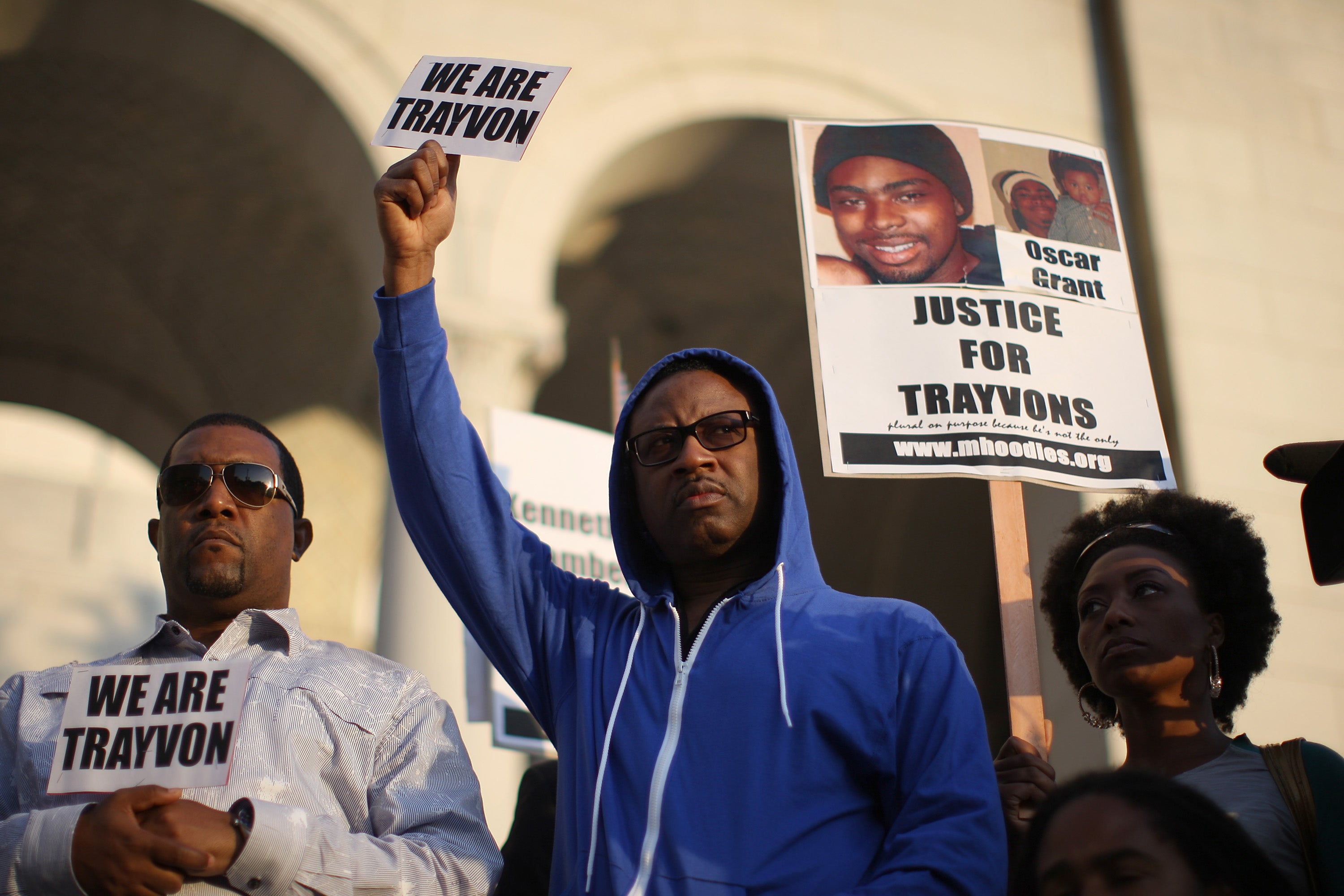 People rally on the steps of City Hall after walking in a silent march to demand justice for the shooting of Trayvon Martin in 2012