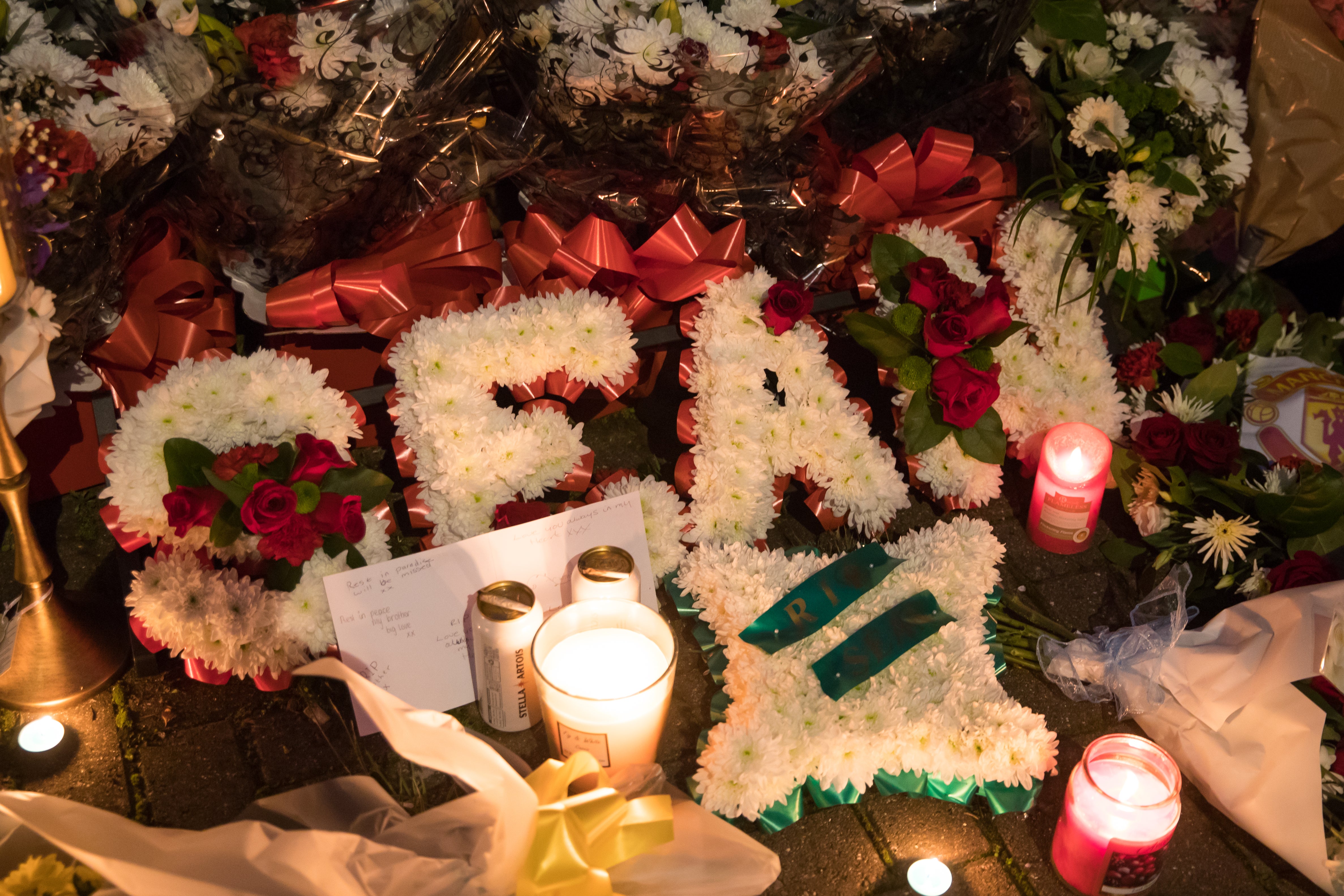 Floral tributes are left at a house on Burnaby Road in Coventry (PA)