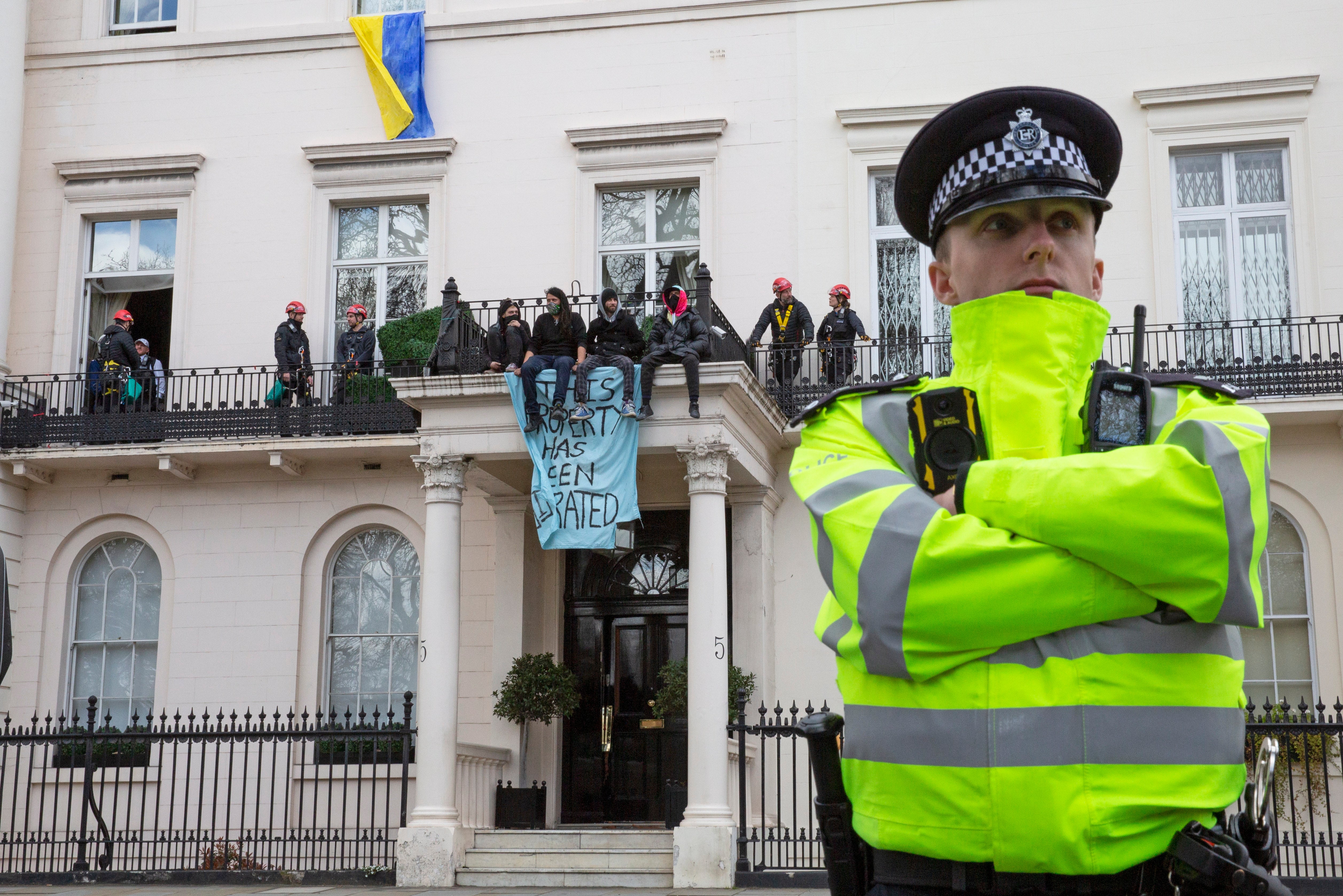 A police officer stands guard outside the Belgrave Square mansion