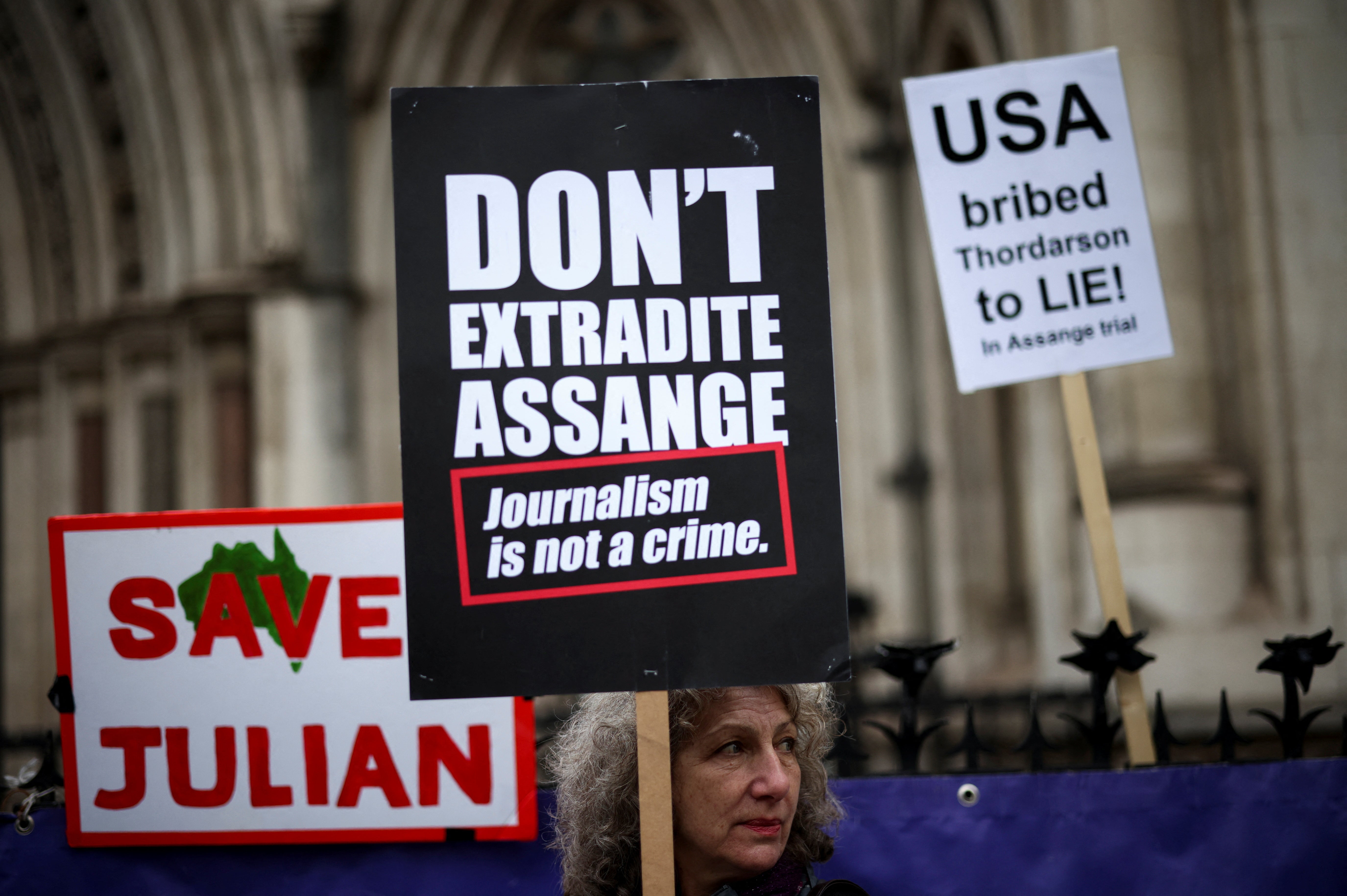 A supporter of WikiLeaks founder Julian Assange protests outside the Royal Courts of Justice in London