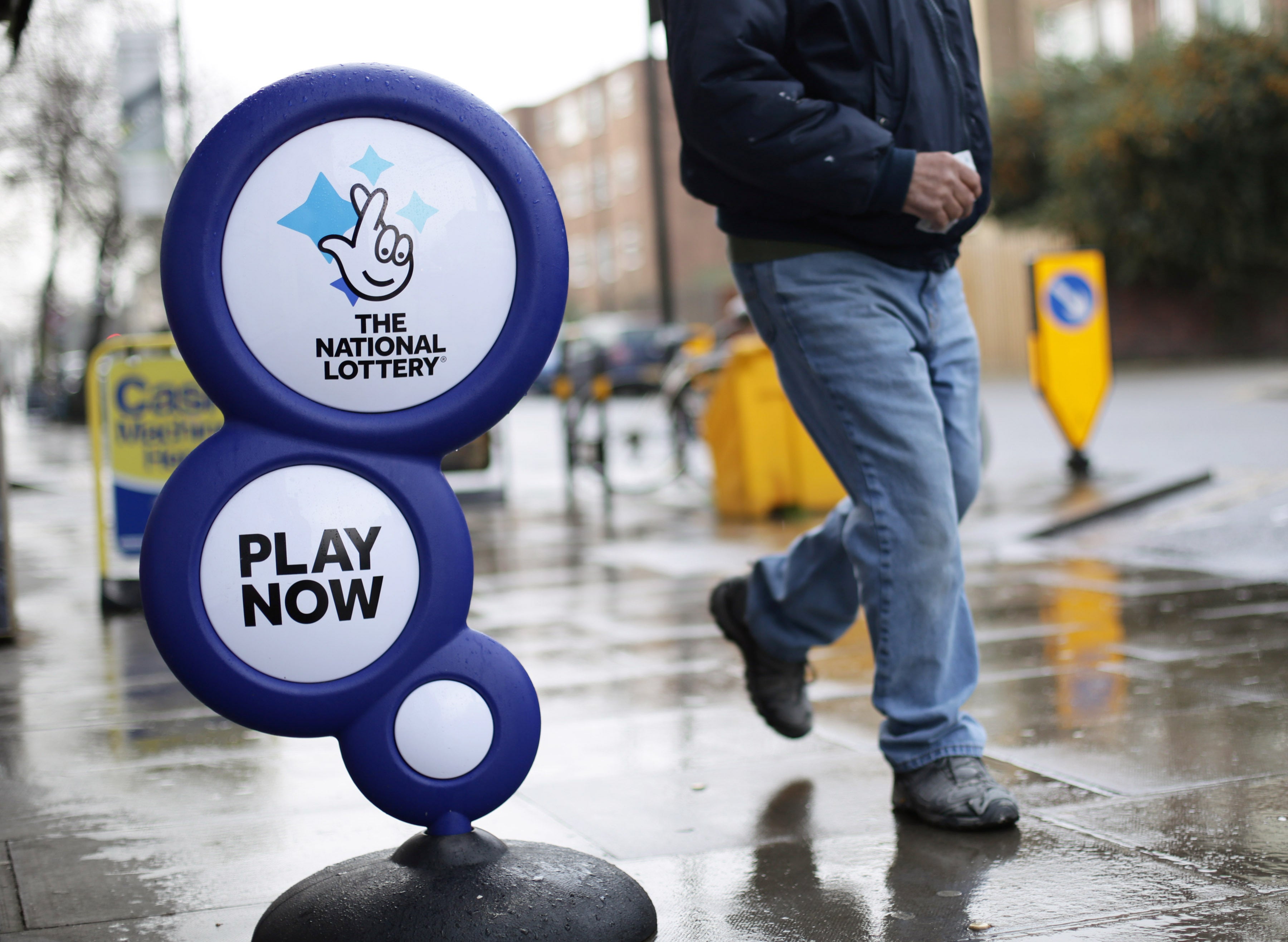 A National Lottery sign outside a newsagent in north London (PA)