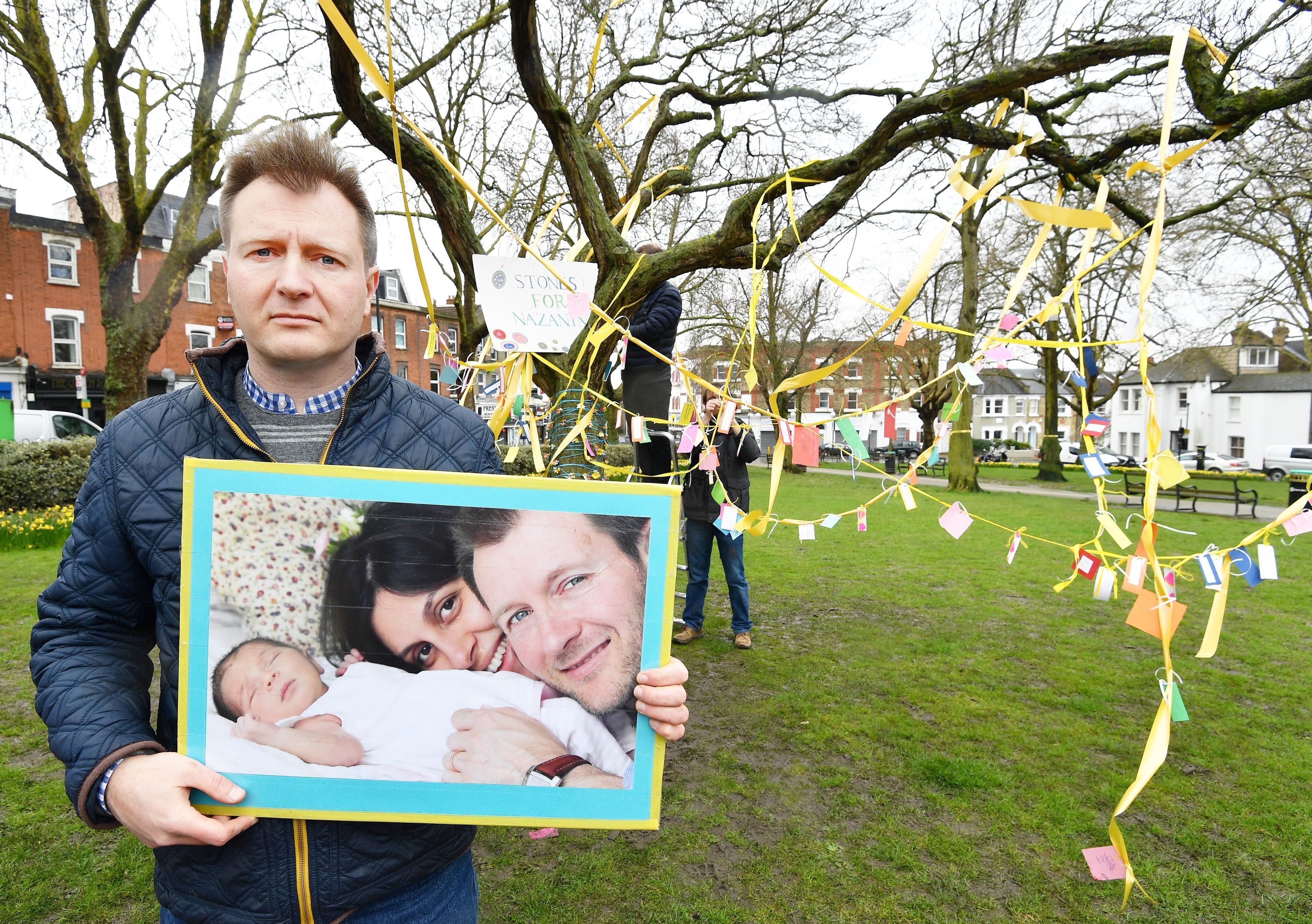 Richard Ratcliffe in front of a decorated tree in Fortune Green in West Hampstead, London, in 2018 (John Stillwell/PA)