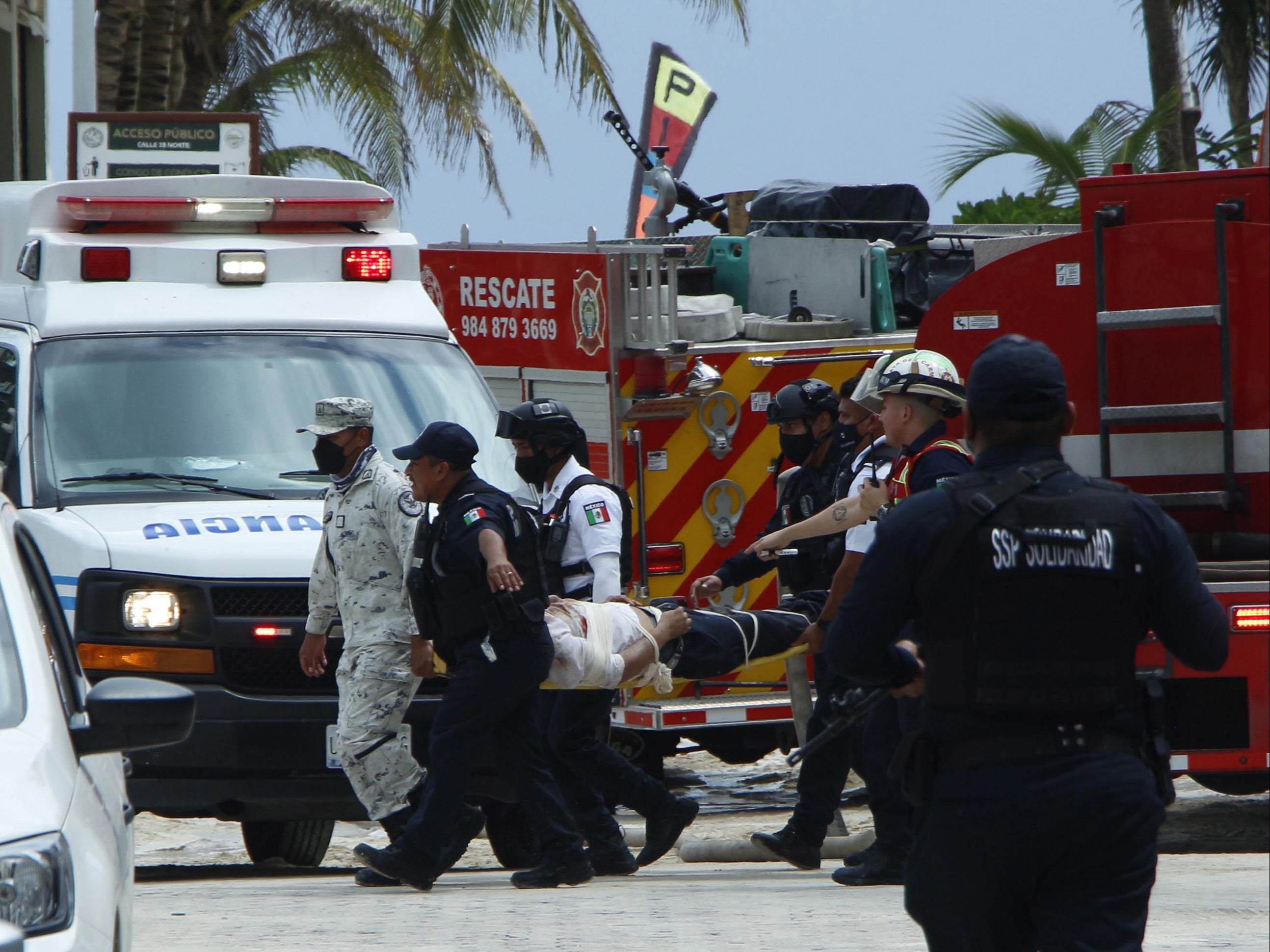 Members of the Mexican Army and emergency and rescue personnel transfer an injured person near a restaurant where there was an explosion in the kitchen area of a Kool Beach beach club in Playa del Carmen