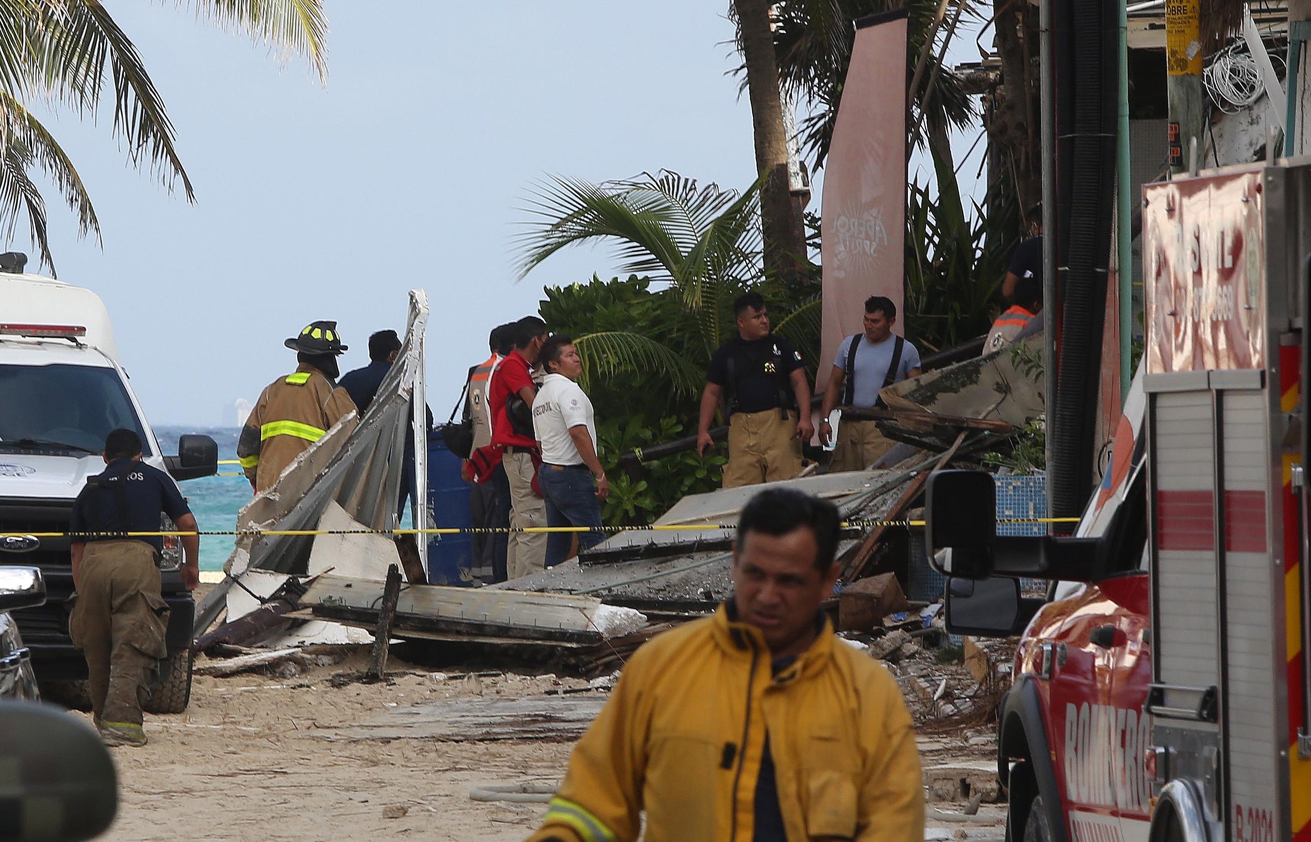 Firefighters work near a restaurant where there was an explosion in the kitchen area of a Kool Beach beach club in Playa del Carmen, in the state of Quintana Roo, Mexico, 14 March 2022