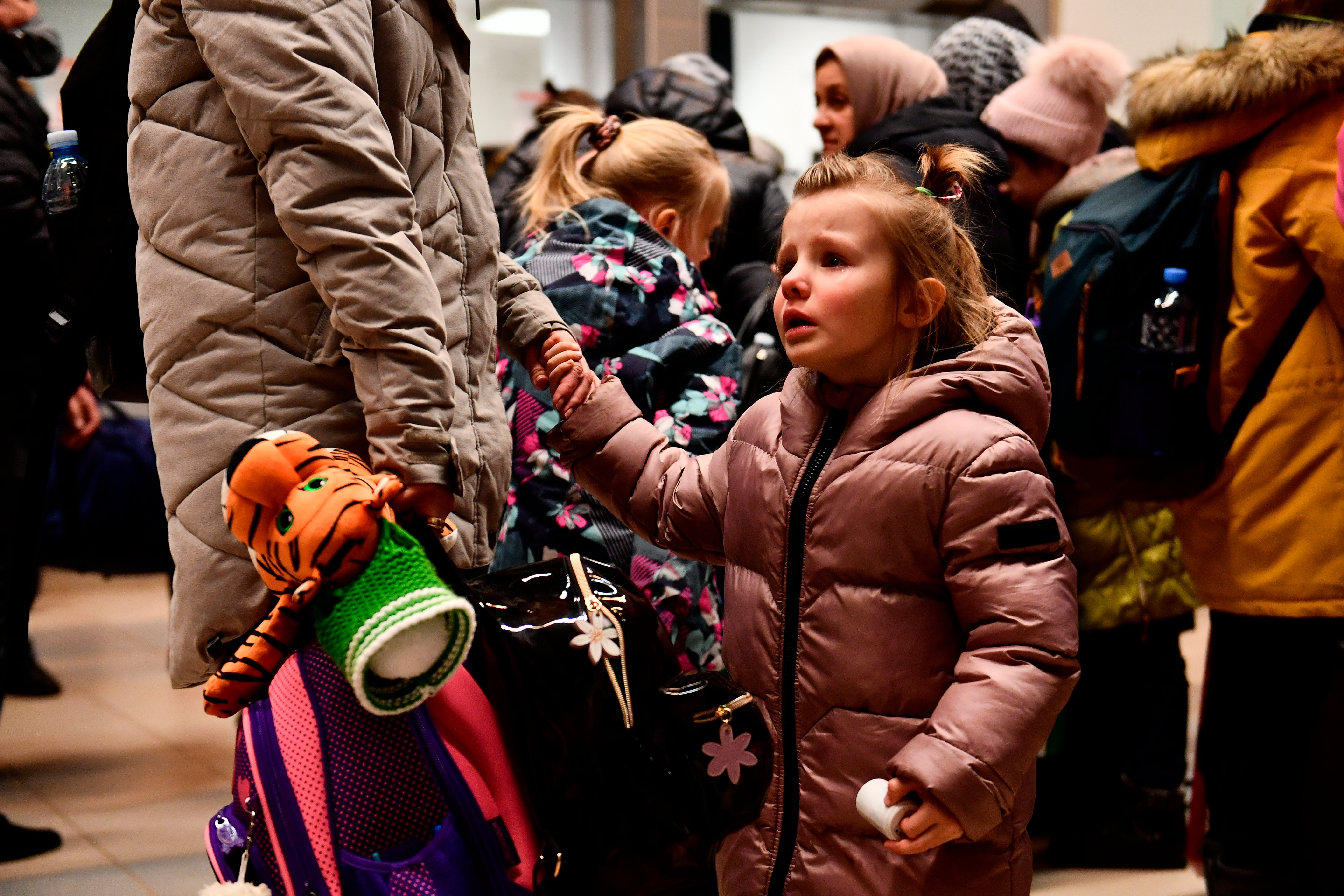 A child fleeing form Ukraine waits with her family at a railway station in Zahony, Hungary