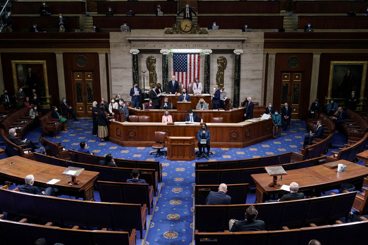 Vice President Mike Pence and Speaker of the House Nancy Pelosi stand after reading the final certification of Electoral College votes cast in November’s presidential election during a joint session of Congress after working through the night, at the Capitol in Washington, U.S.