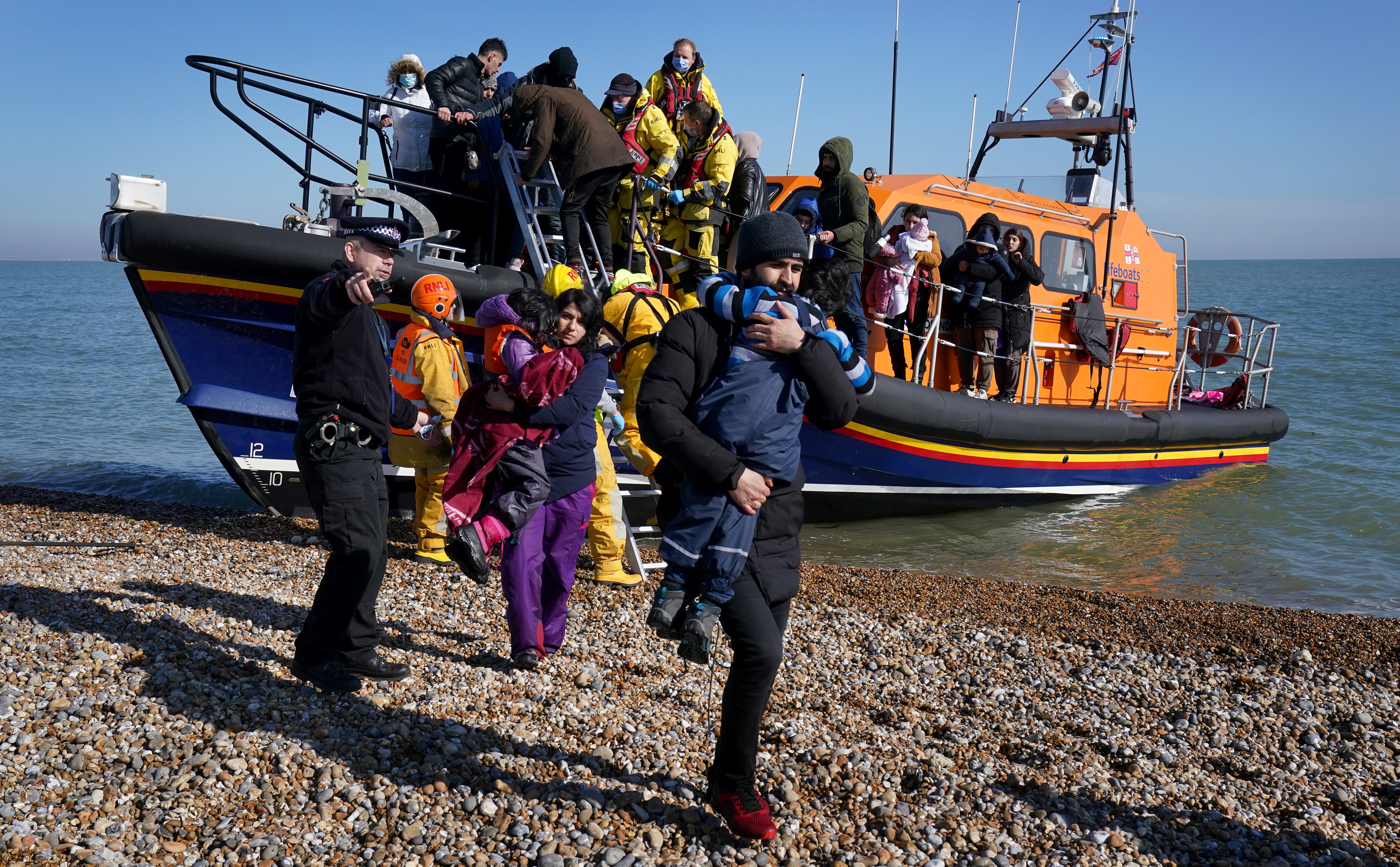 A group of people including young children are brought in to Dungeness, Kent, by the RNLI (Gareth Fuller/PA)