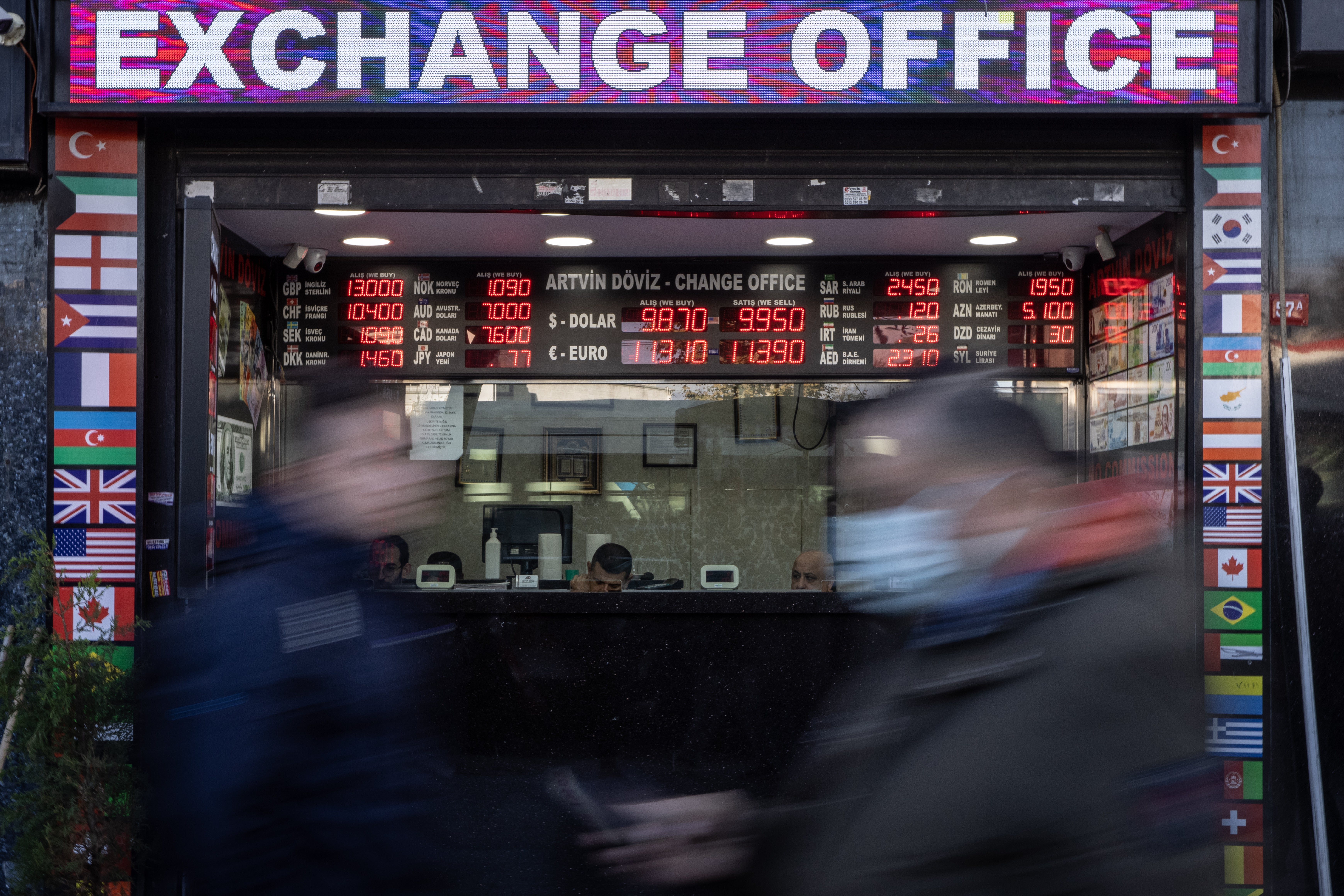 People walk past a currency exchange office in Istanbul, Turkey, 11 November 2021