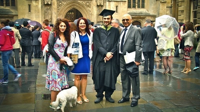 Mr Ashoori pictured with his family before his arrest