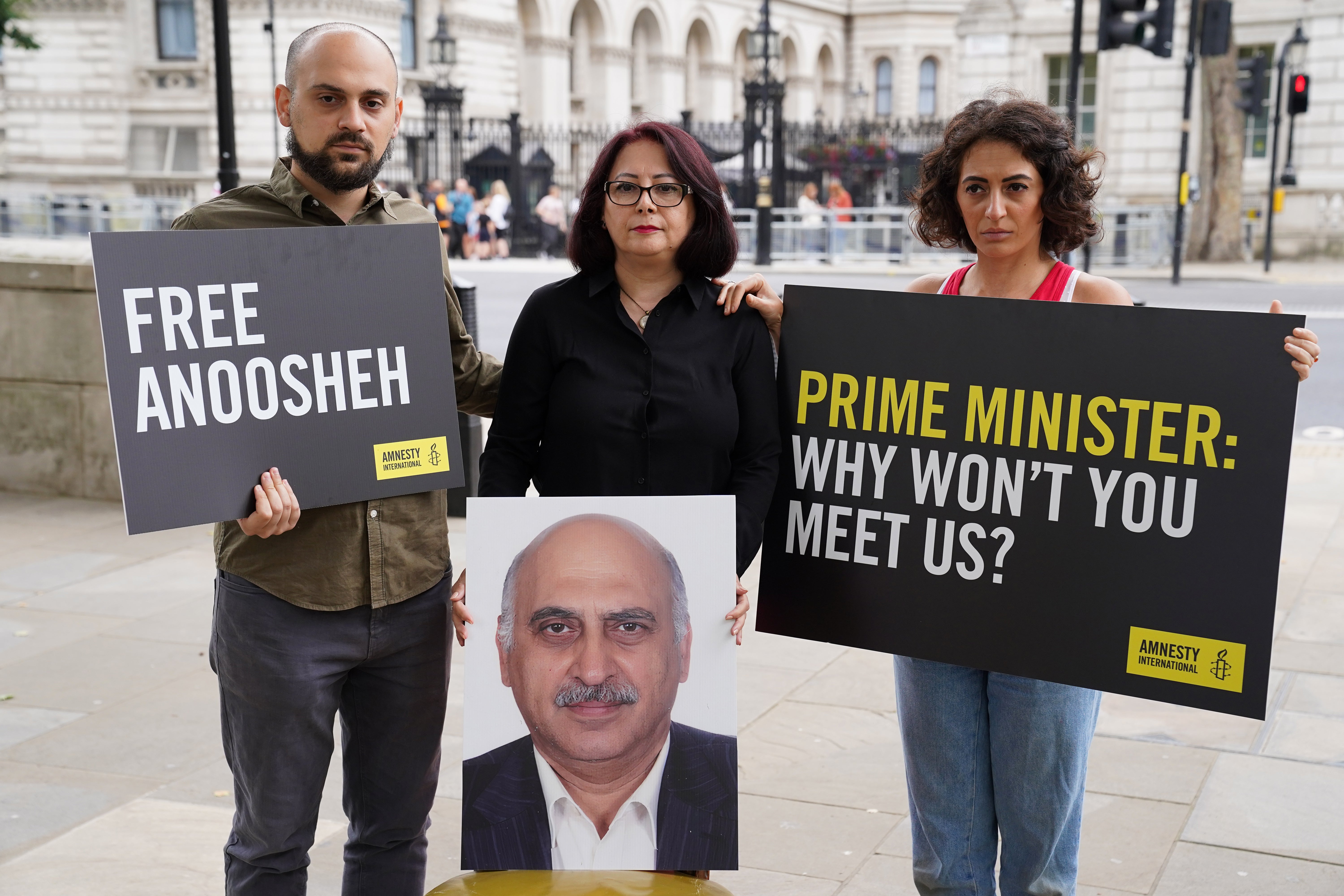 (L-R) Aryan Ashoori, Sherry Izadi and Elika Ashoori, the son, wife and daughter of Mr Ashoori, protested outside Downing Street in 2021.