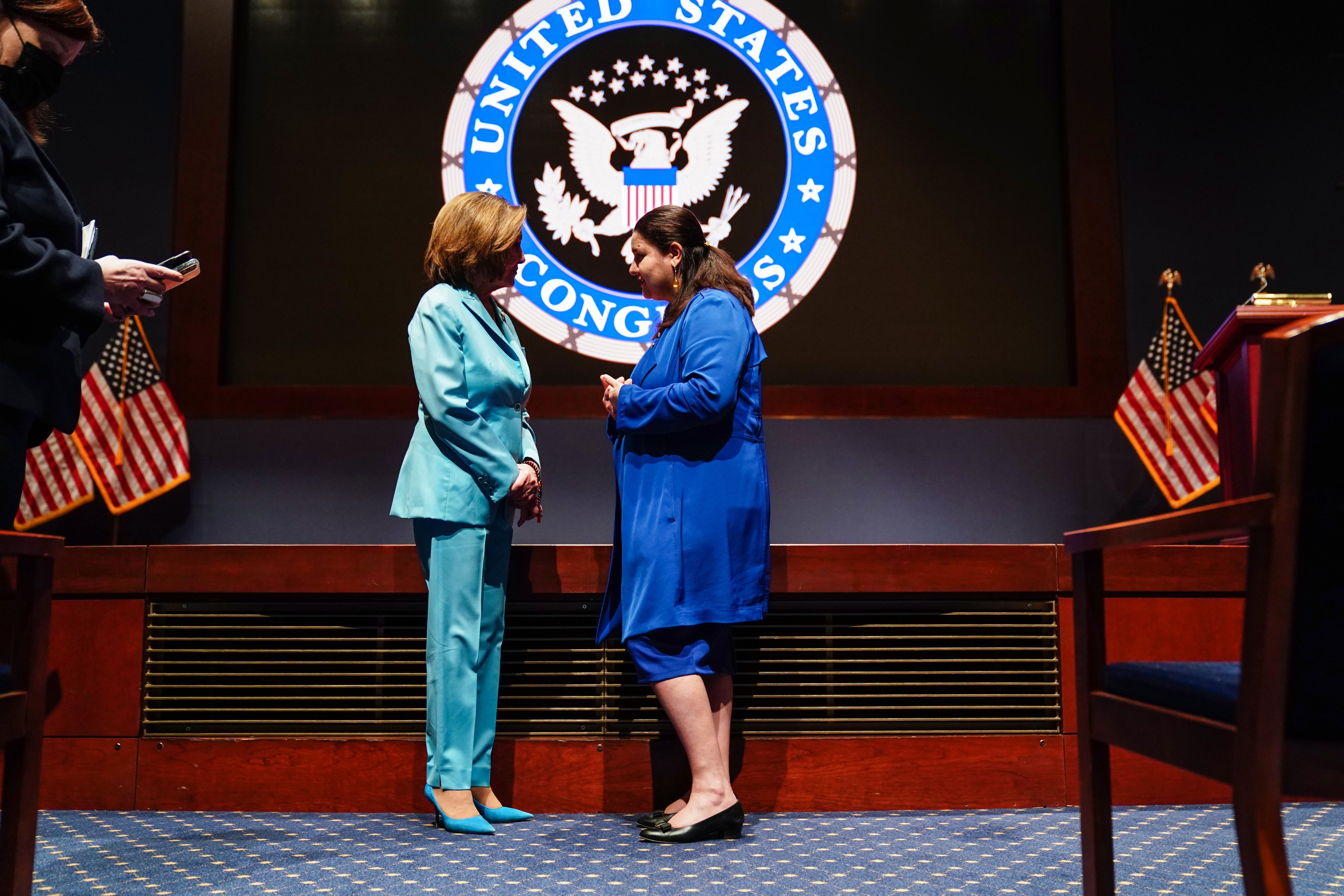 Ukrainian Ambassador to the US, Oksana Markarova (R) talks with US House Speaker Nancy Pelosi (L) after Ukraine's President Volodymyr Zelensky delivered a video address to senators and members of the House of Representatives gathered in the Capitol Visitor Center Congressional Auditorium.