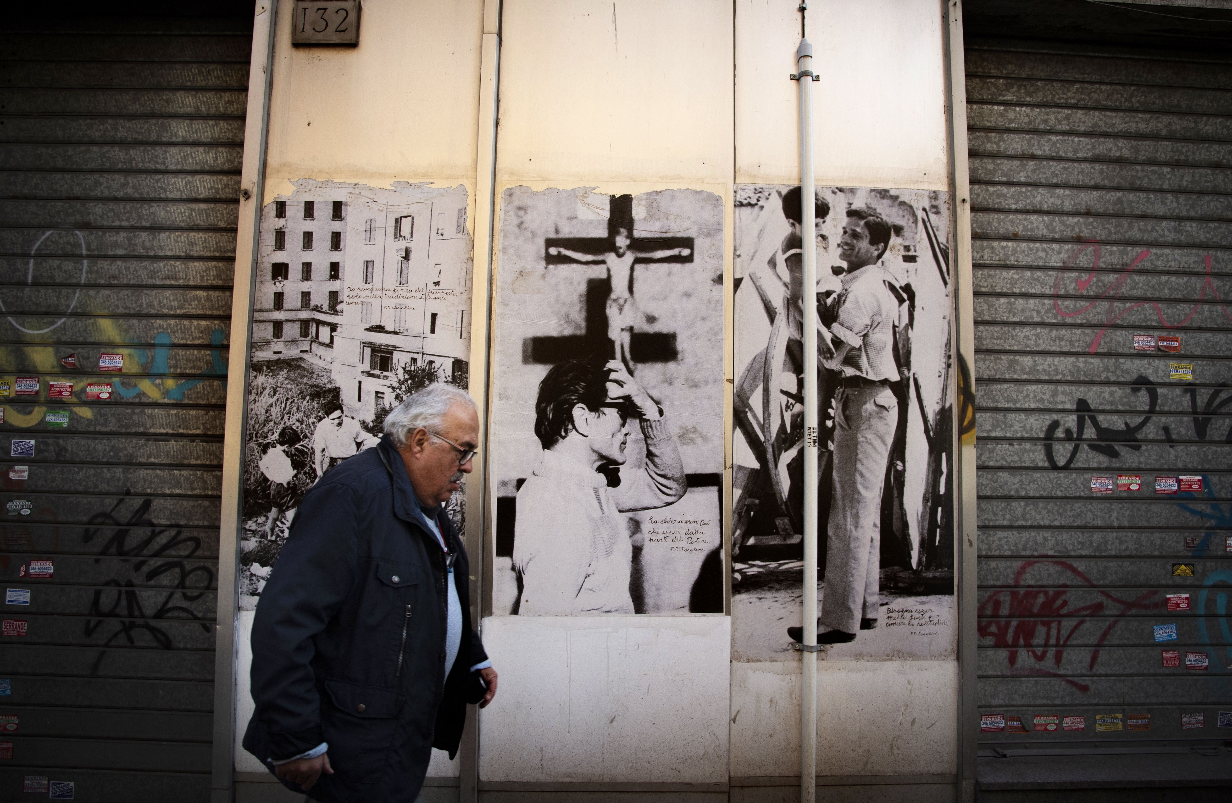 Pictures of Pasolini adorn a workshop. The director would have been 100 years old this month