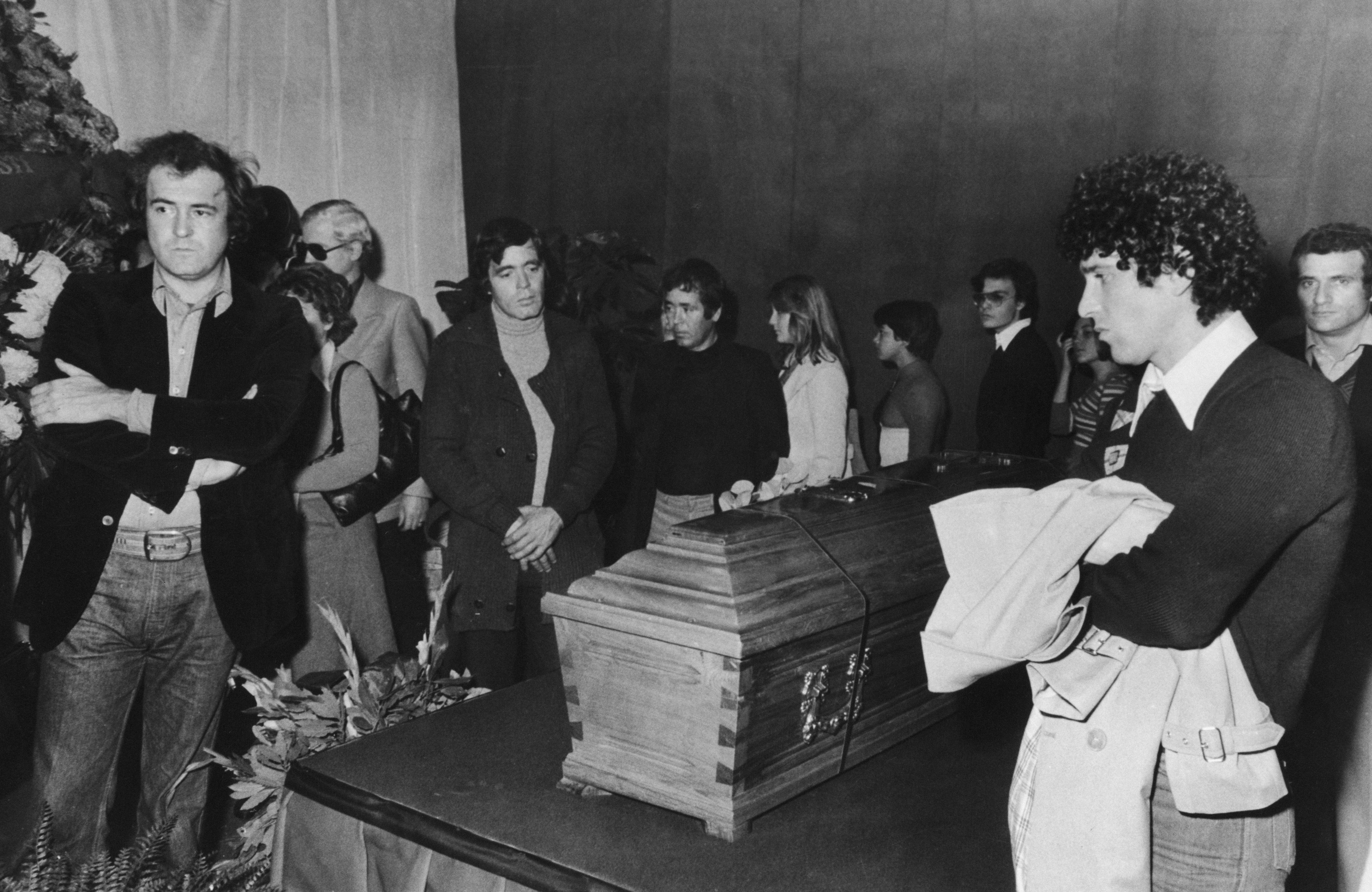 The funeral of Pasolini in Rome, November 1975. Present are director Bernardo Bertolucci (left), actor Franco Citti, writer Sergio Citti and actor Ninetto Davoli (right)