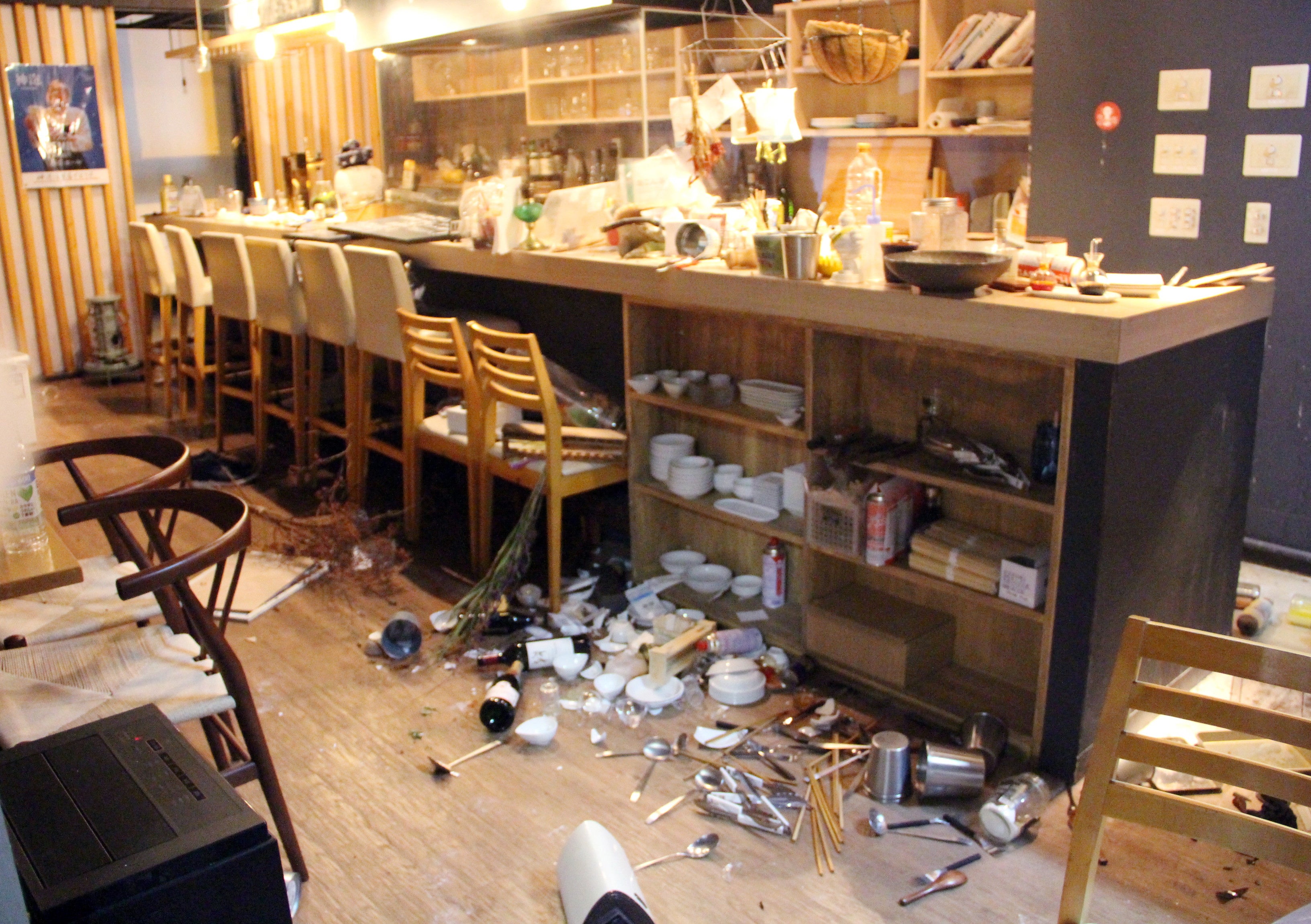 A restaurant floor is covered with broken plates and products in Fukushima, northeastern Japan, late on 16 March