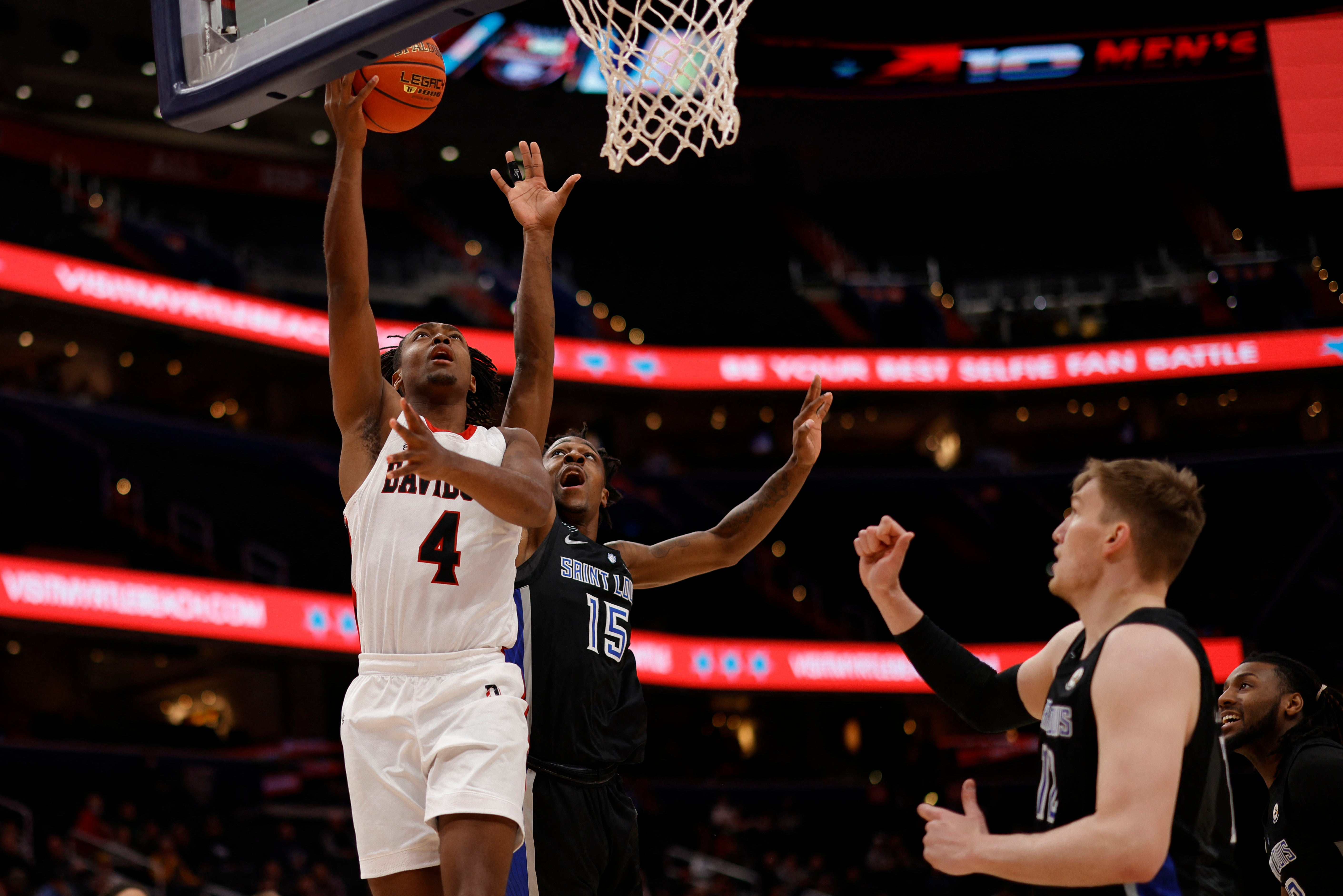 Washington, D.C., USA; Davidson Wildcats guard Desmond Watson (4) shoots the ball as Saint Louis Billikens guard Jordan Nesbitt (15) defends in the first half at Capital One Arena