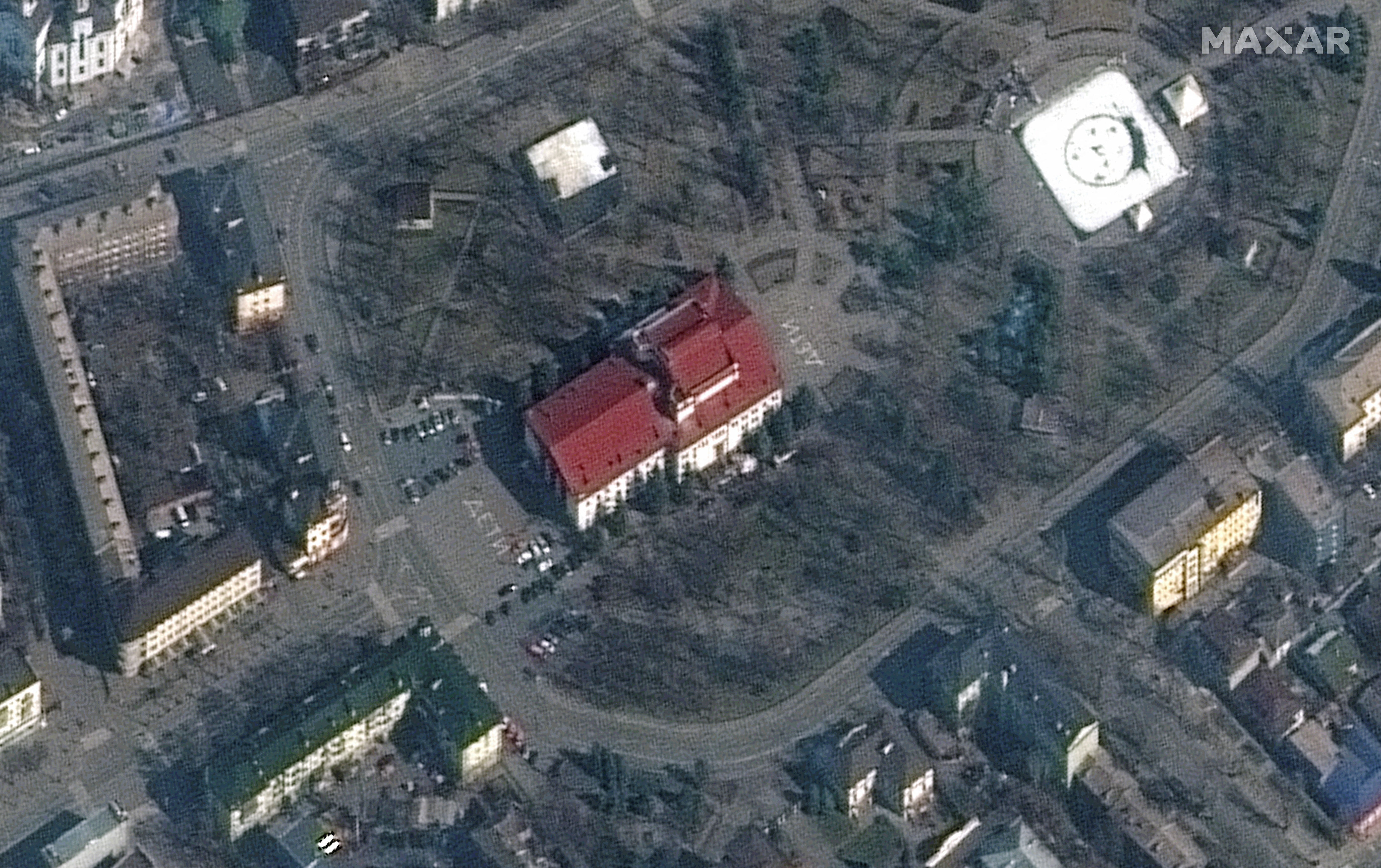 A satellite image of the Donetsk Regional Theatre of Drama, taken days before the bombing, shows the Russian word for ‘children’ written in large white letters in front of and behind the building