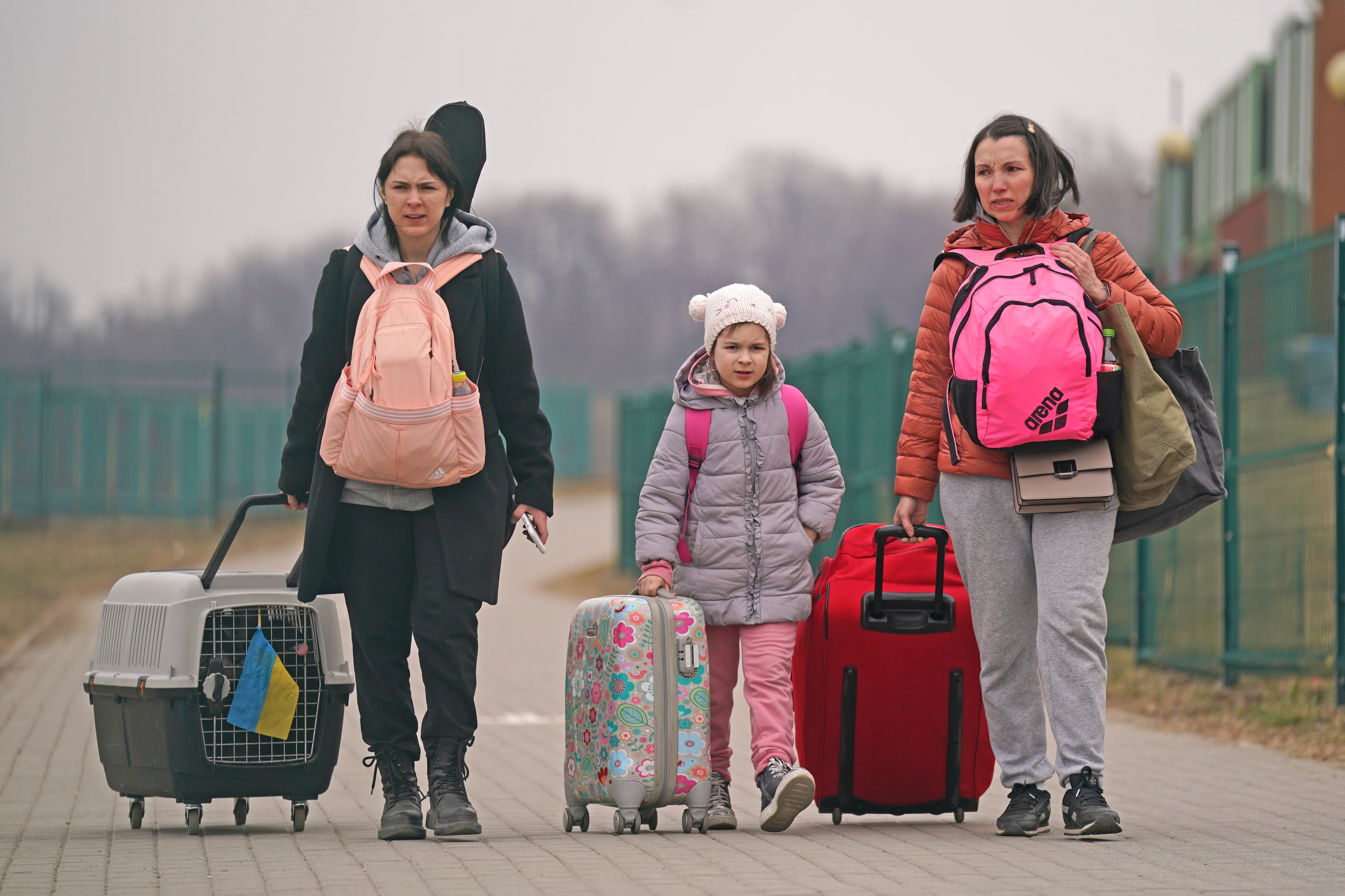 People cross the border point from Ukraine into Medyka, Poland as Russia’s bombing campaign intensifies