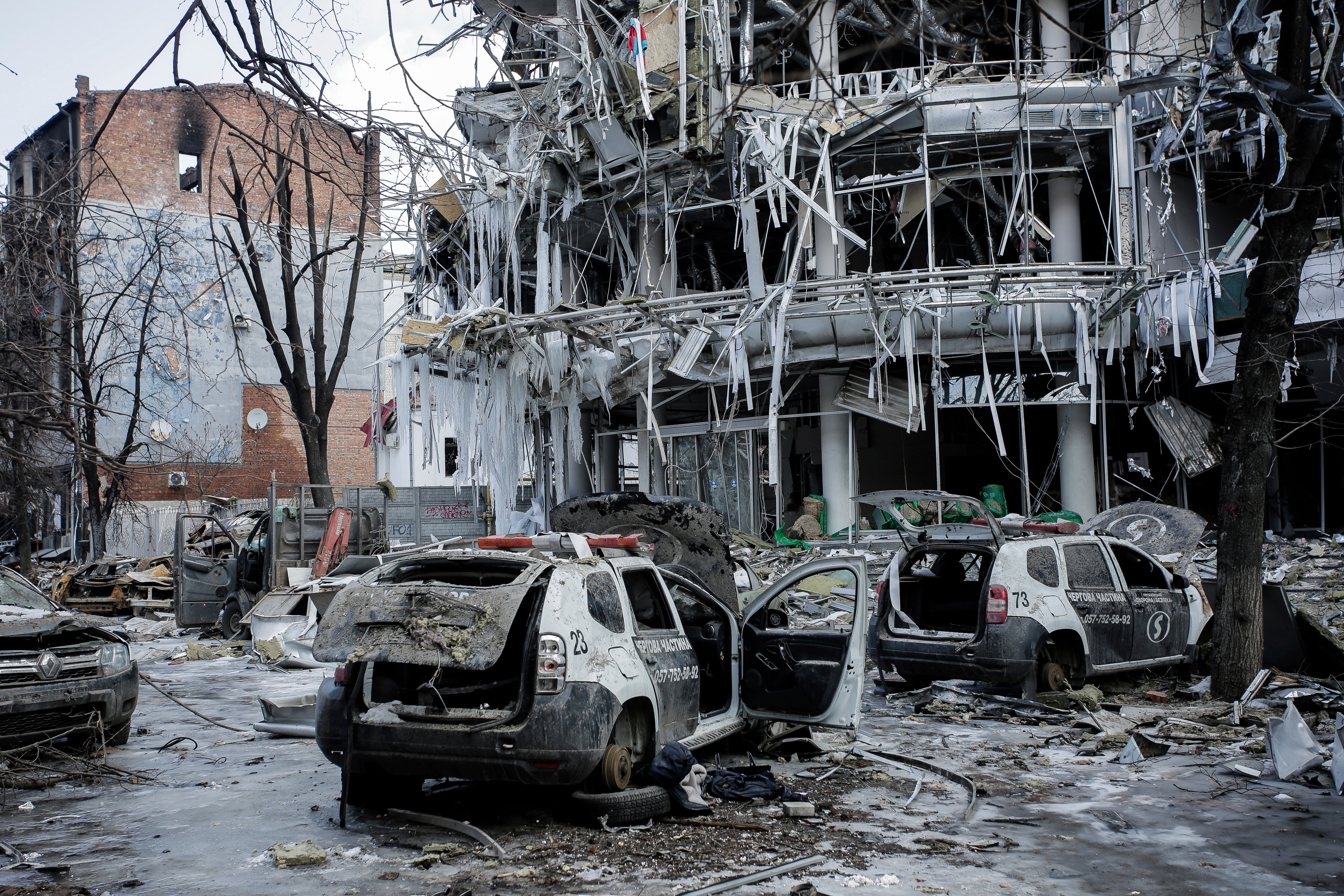 Damaged vehicles sit among debris and in Kharkiv city centre in Ukraine, Wednesday