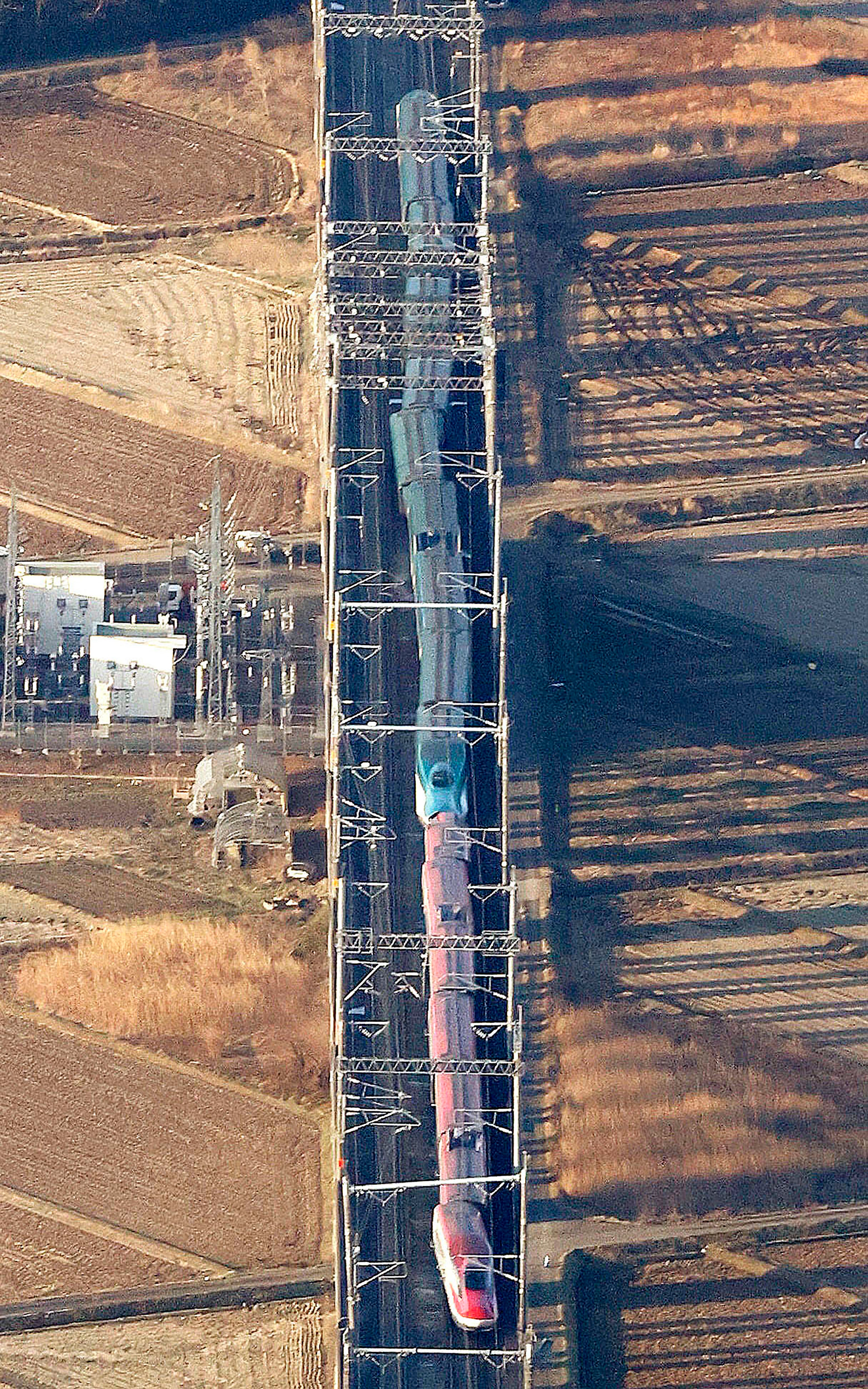 This aerial photo shows a partially derailed express train following an earthquake in Shiroishi, Miyagi prefecture, northern Japan, on Thursday