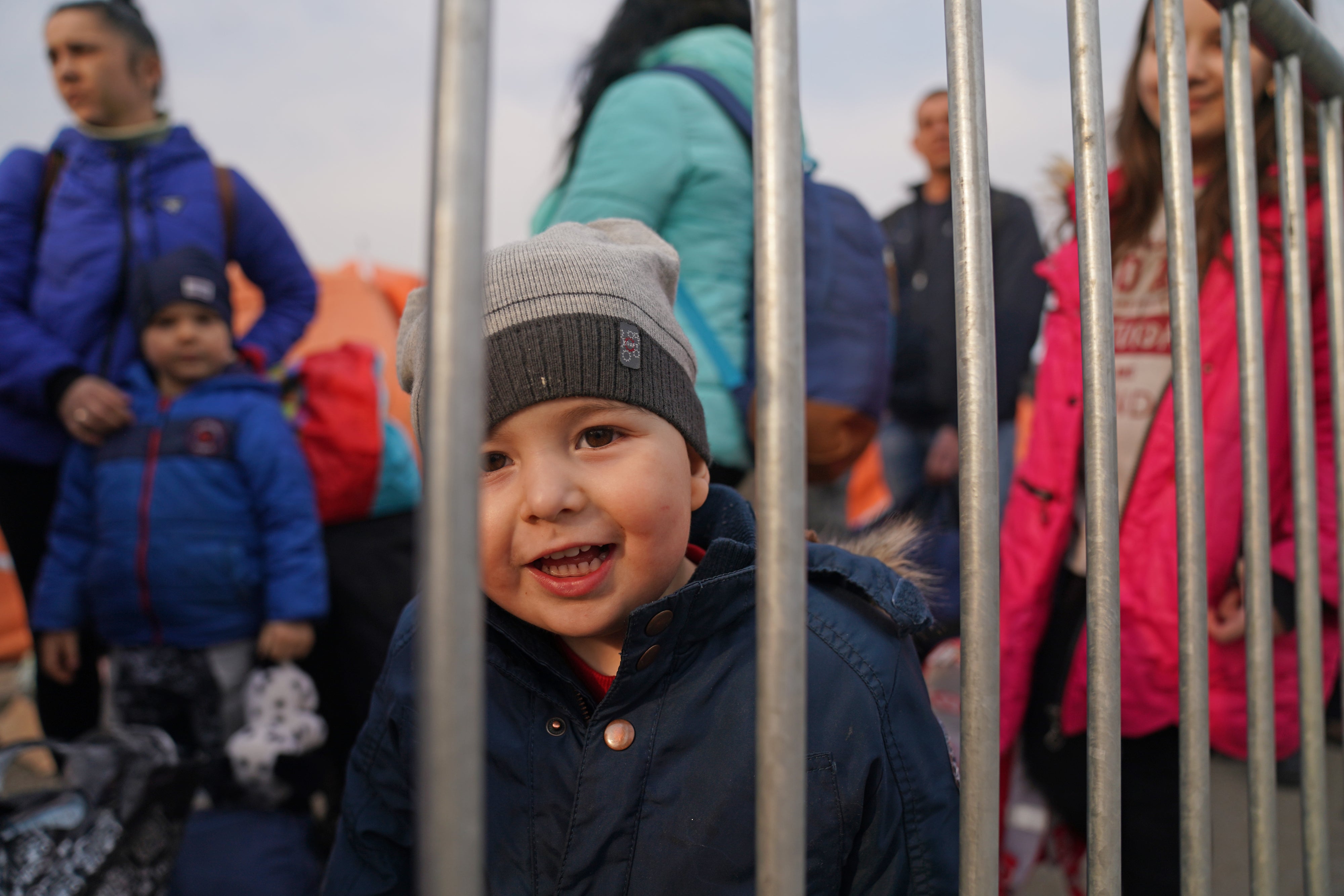 People who have crossed the border point from Ukraine into Medyka, Poland, wait to board a bus (Victoria Jones/PA)