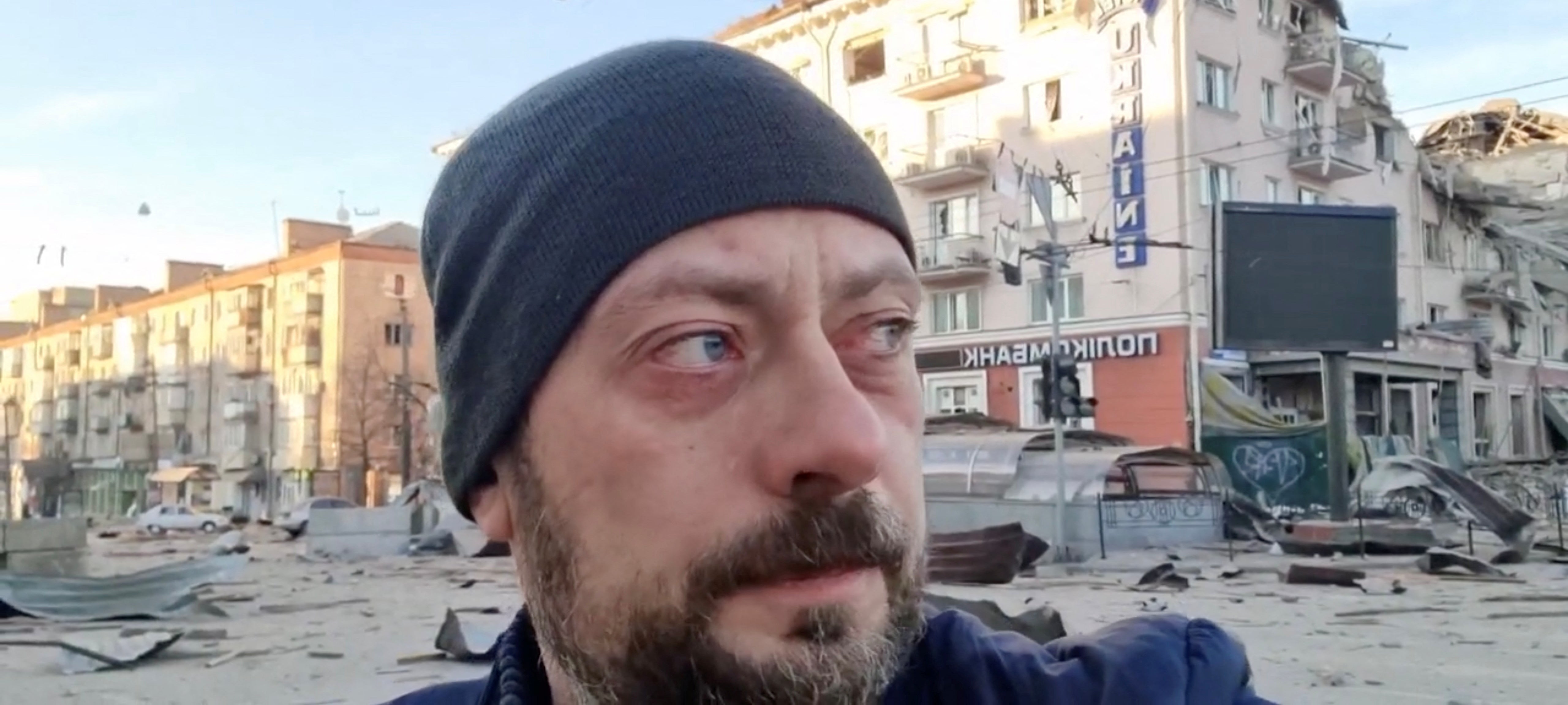 Viacheslav Chaus, governor of the Chernihiv regional state administration, reacts during a video statement, with Hotel Ukraine and other damaged buildings in the background