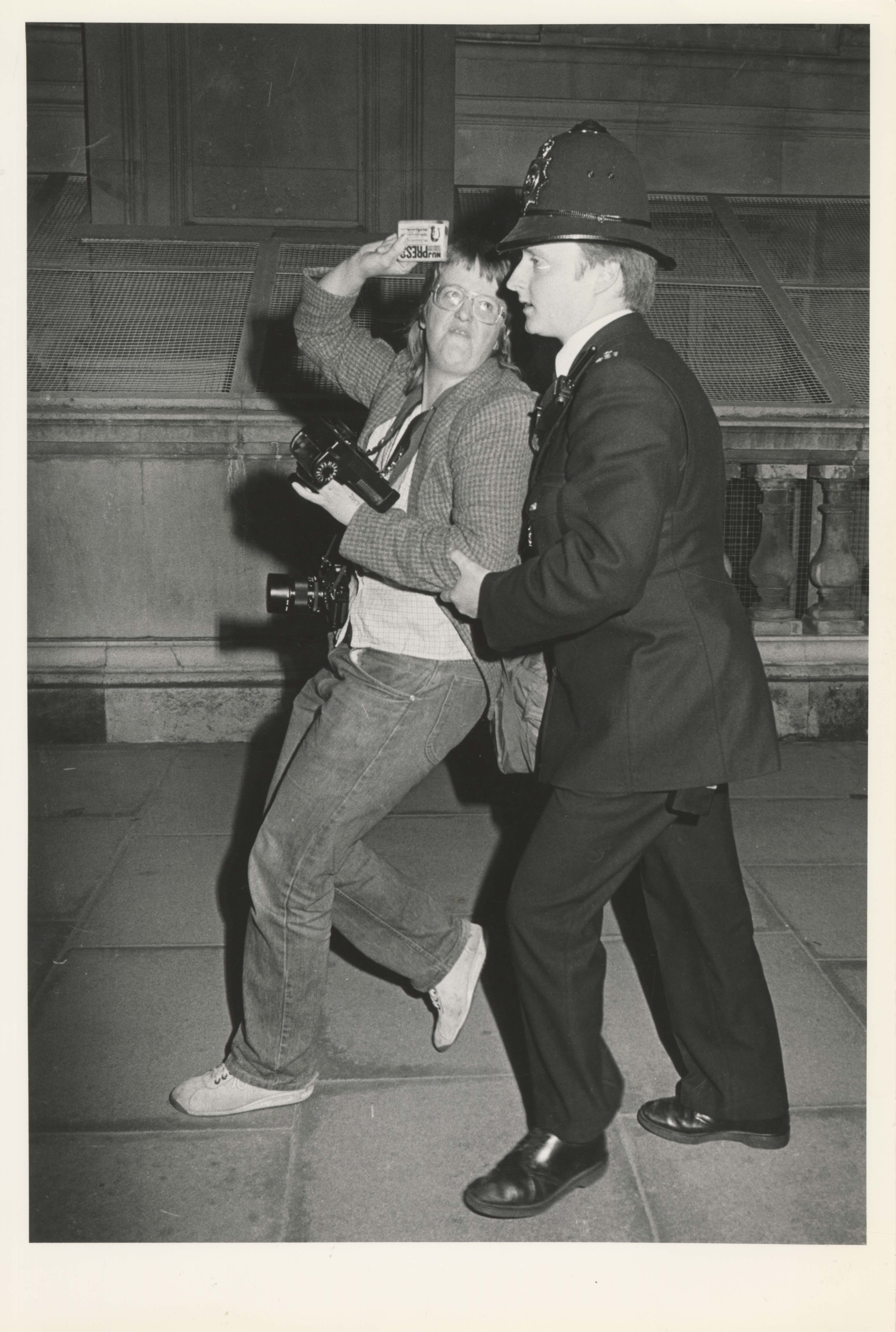 Photographer Pam Isherwood being moved on at an International Day of Disarmament protest in 1983