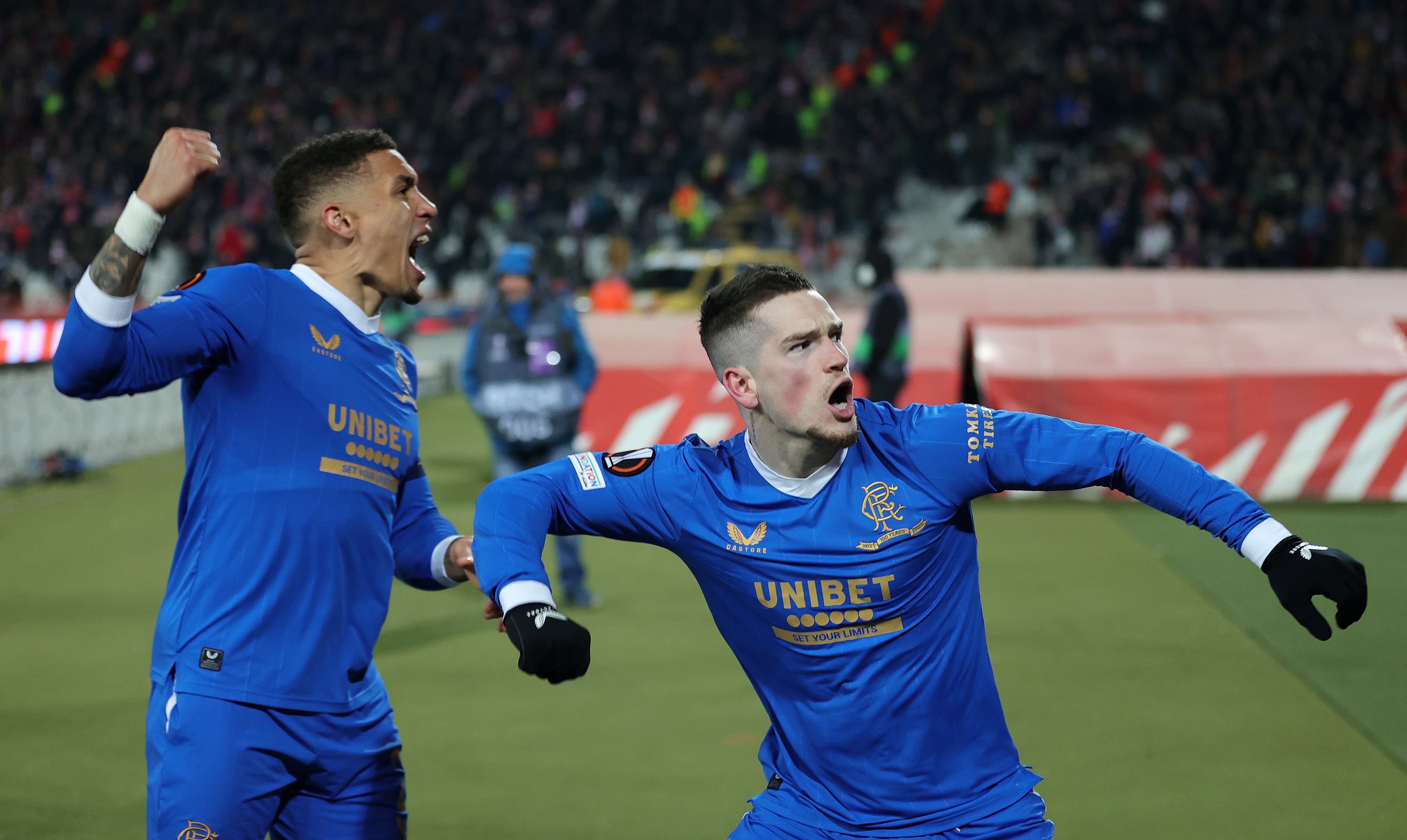 Ryan Kent of Rangers celebrates with teammate James Tavernier after scoring in Belgrade