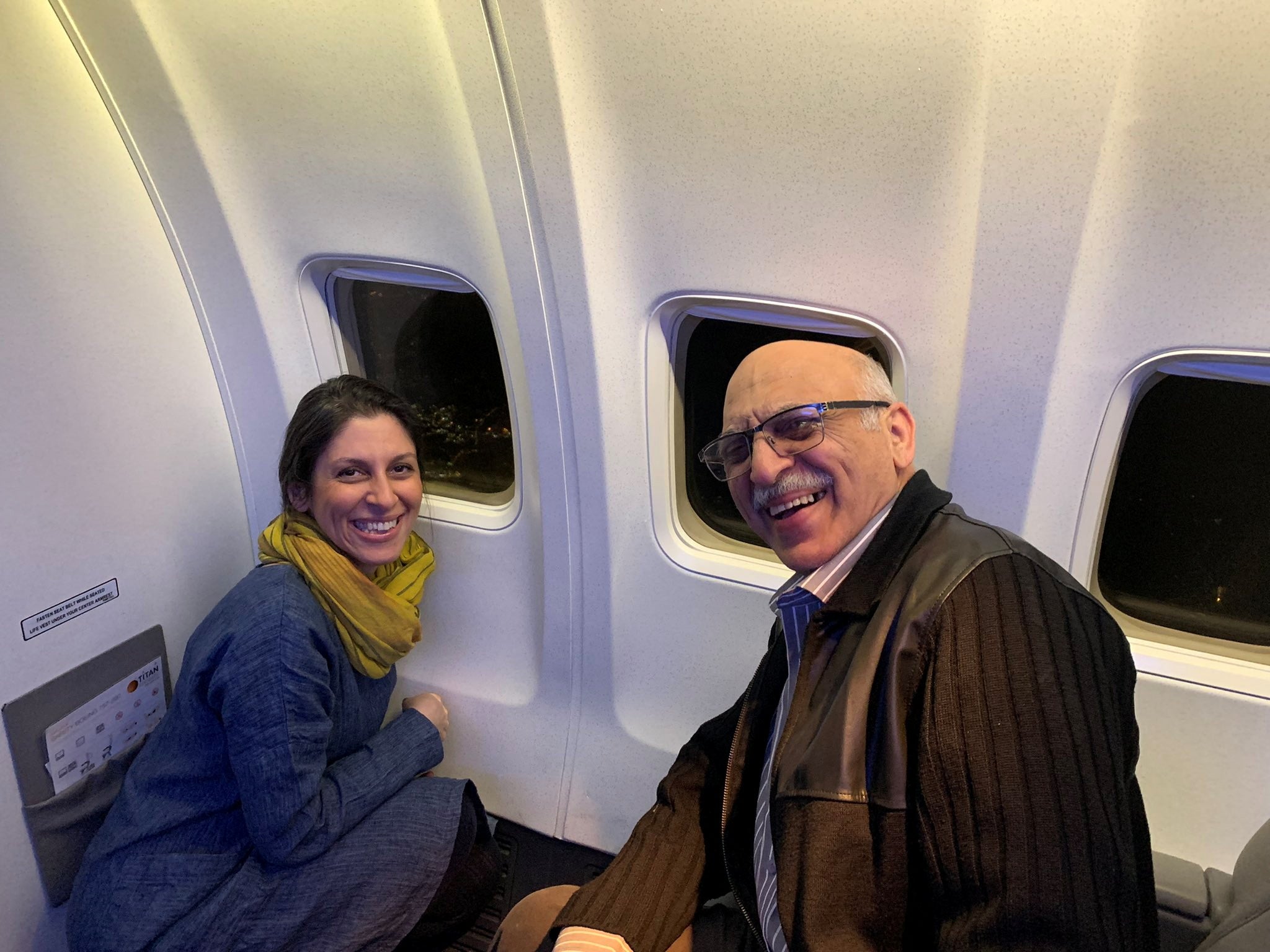 British-Iranian aid worker Nazanin Zaghari-Ratcliffe and dual national Anoosheh Ashoori smile as they sit in a plane flying over London