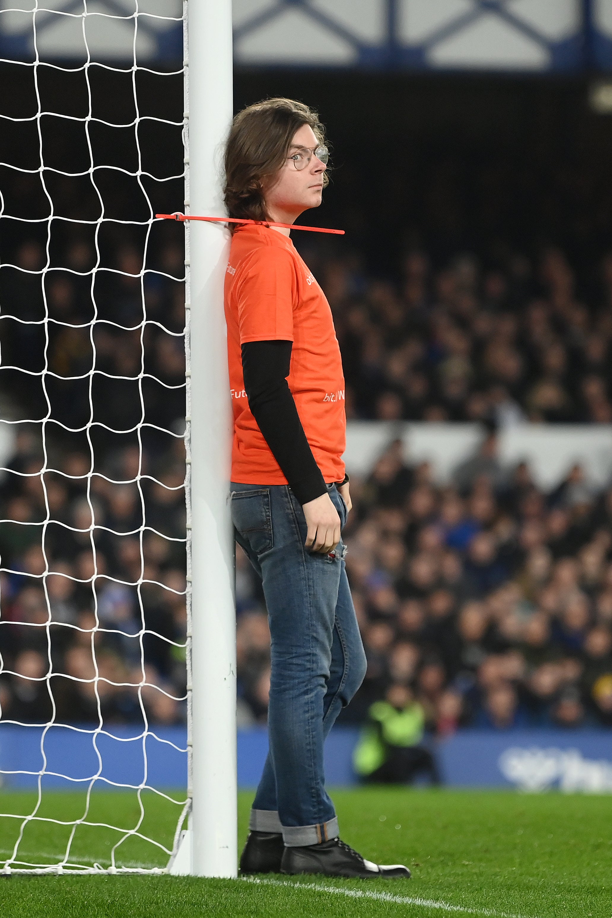 A fan ties himself to the net in protest during the Premier League match between Everton and Newcastle United