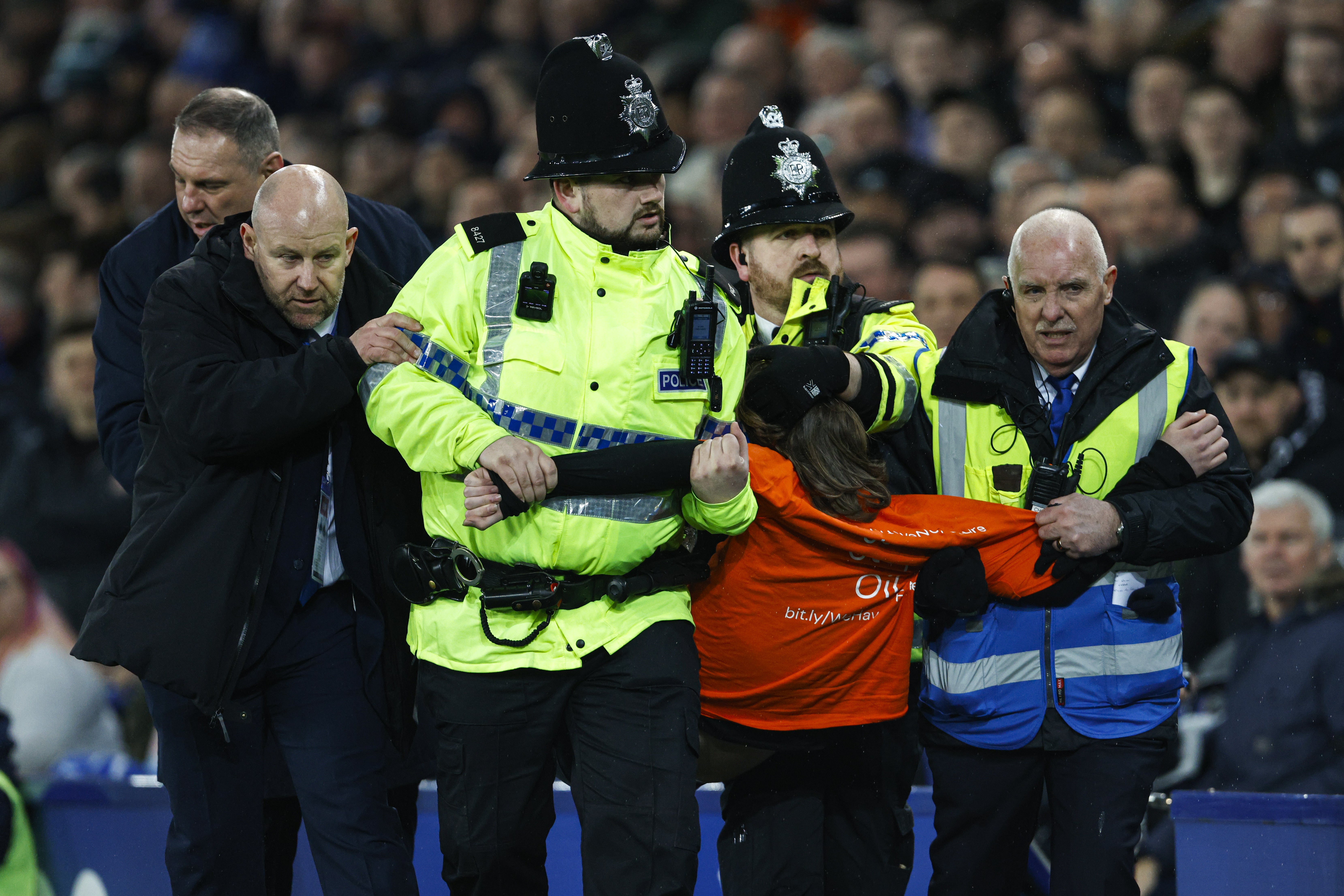 The protester was led away by police (Richard Sellers/PA)