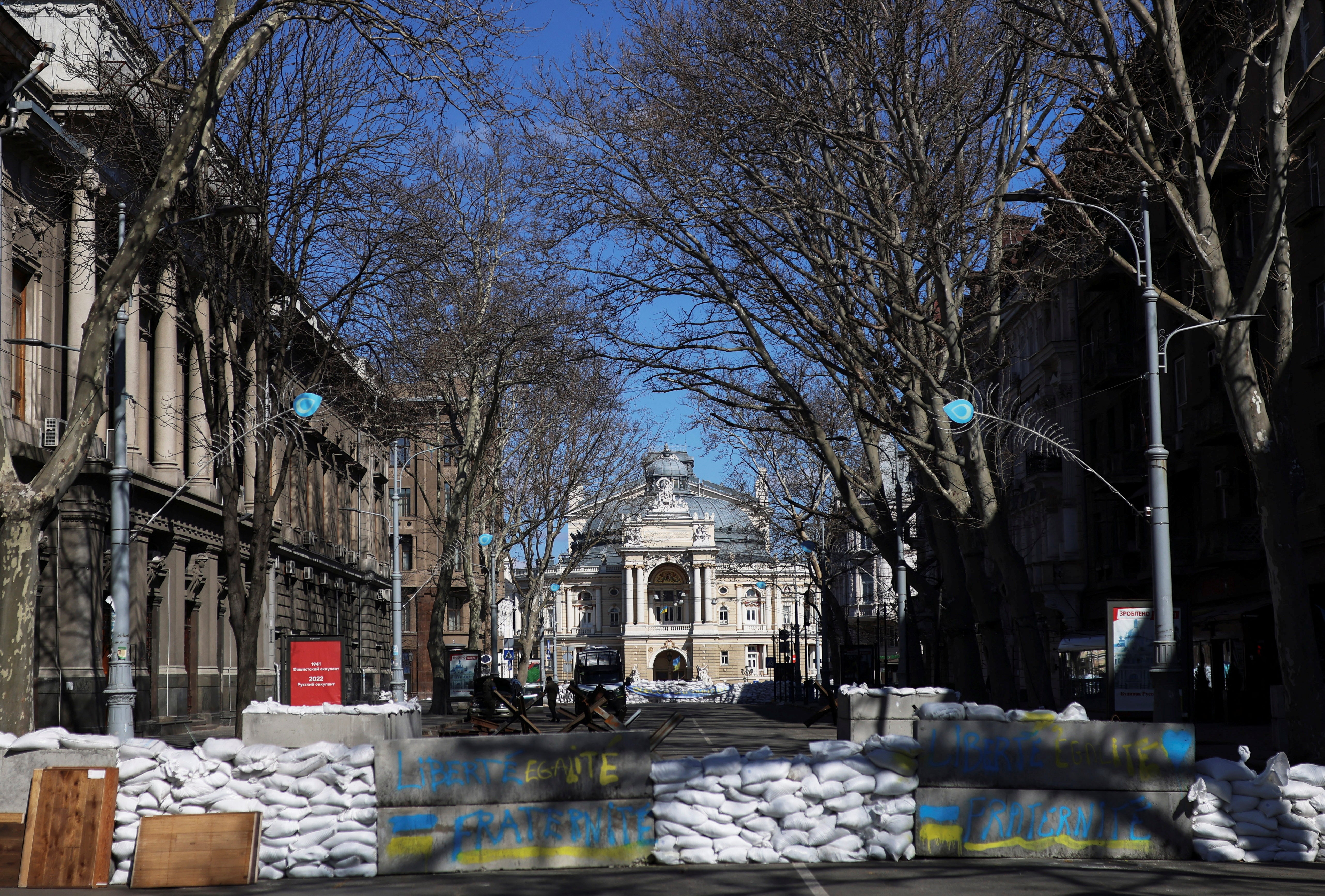 Ukrainian service members patrol in front of the National Academic Theatre of Opera and Ballet in Odessa