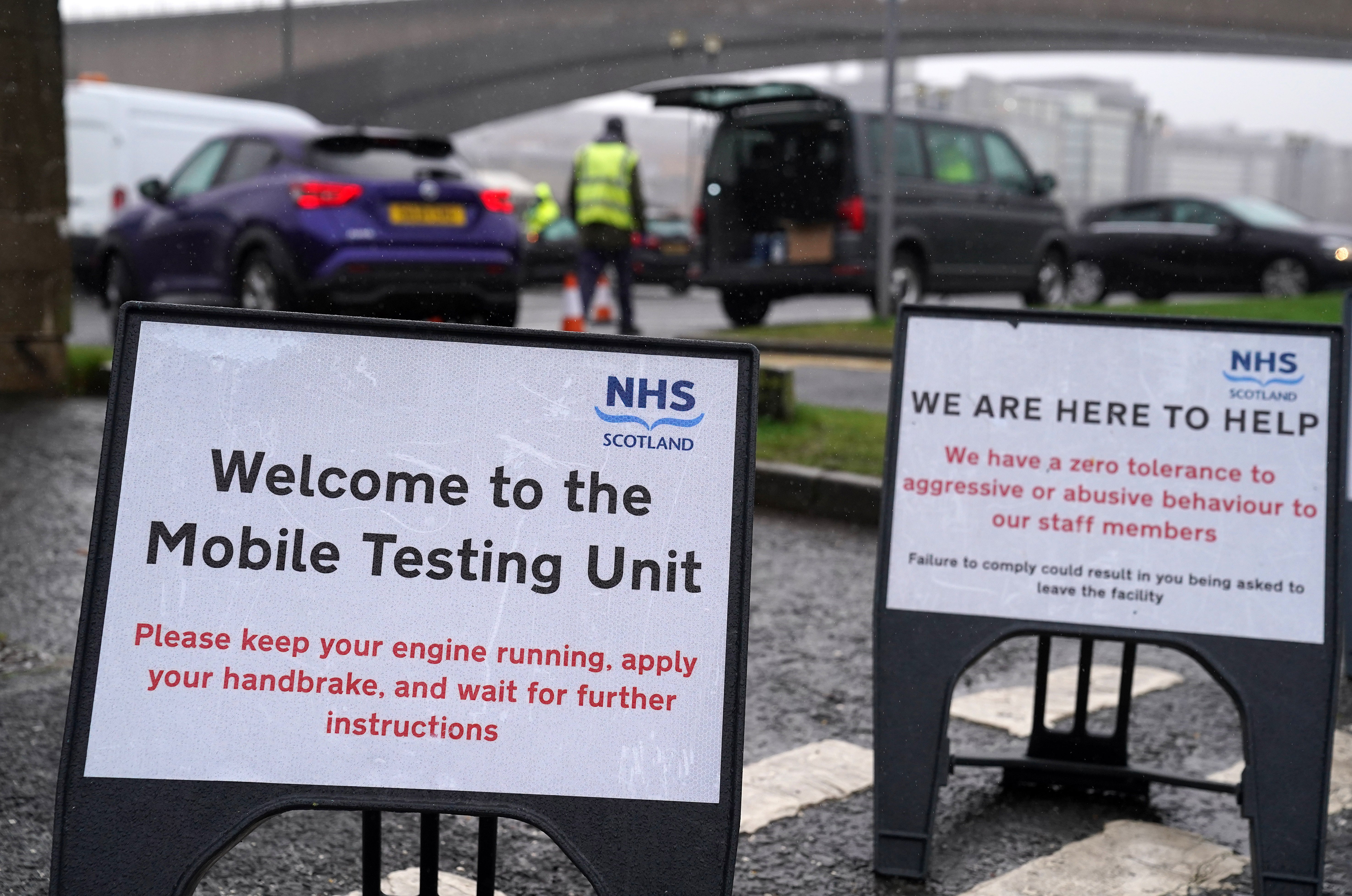 Signs at a mobile Covid-19 test site in Glasgow (Andrew Milligan/PA)