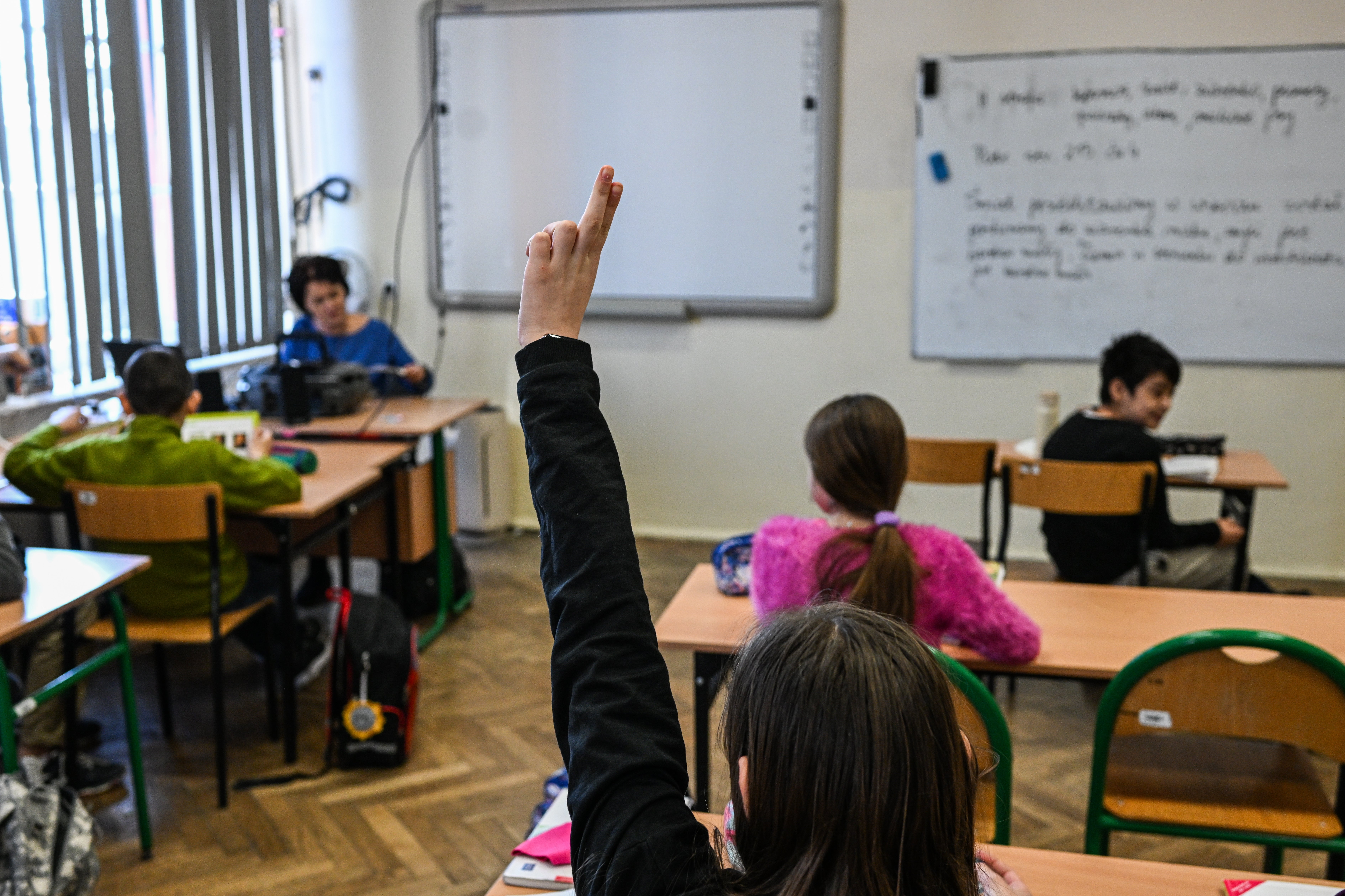 Children who fled the war in Ukraine take part in a primary school class together with Polish pupils