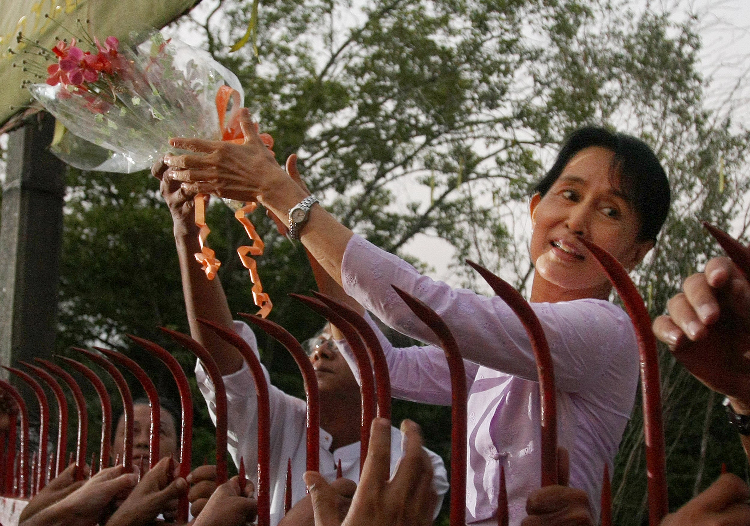 Opposition leader Aung San Suu Kyi greets supporters after her release in Yangon in 2010