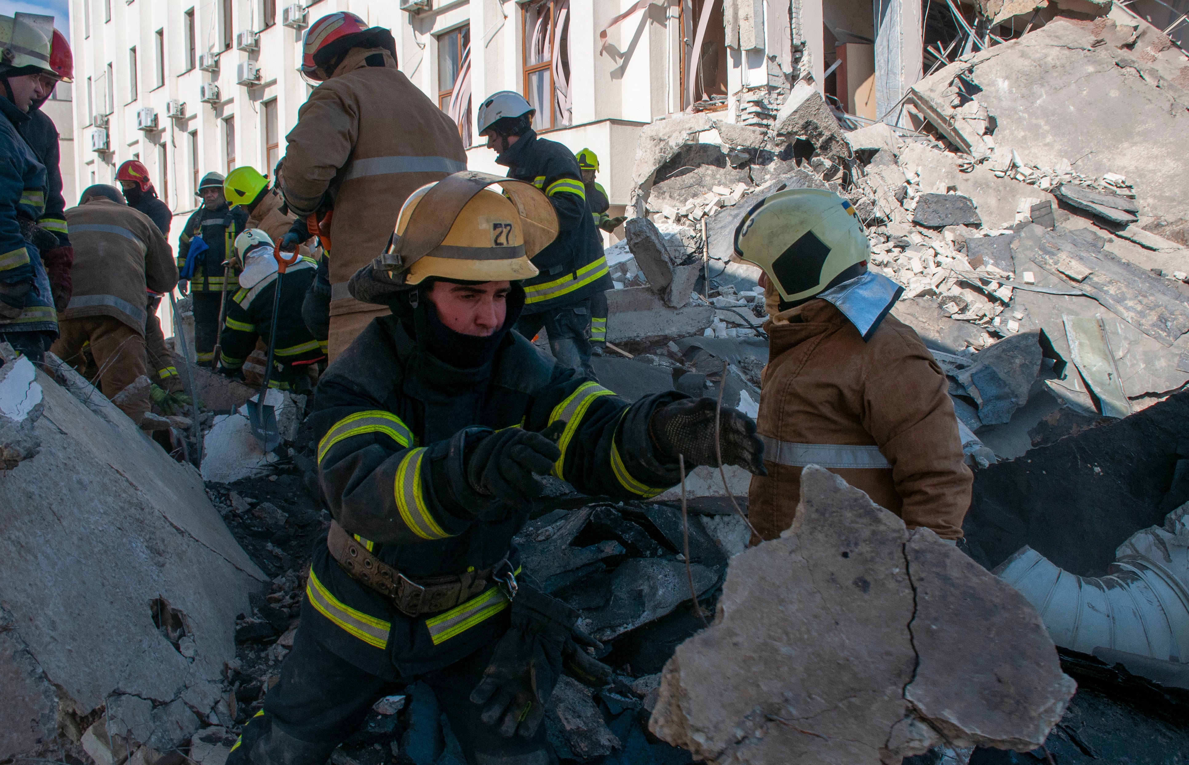 Ukrainian rescuers clean the debris of a shelled building in Kharkiv on Friday