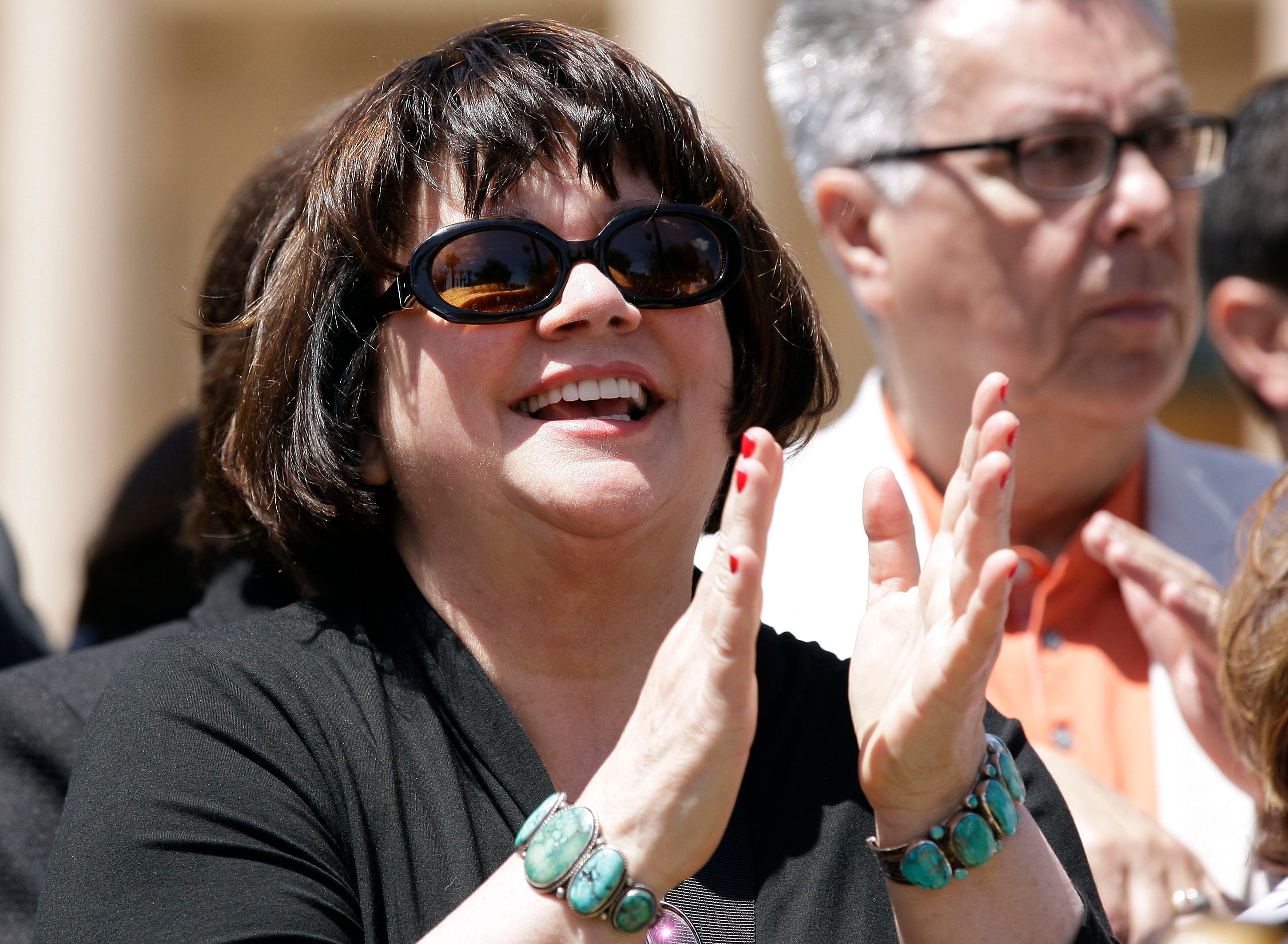 Singer and activist Linda Ronstadt, an Arizona resident, applauds a speaker as she attends a news conference at the Arizona Capitol, Thursday, April 29, 2010