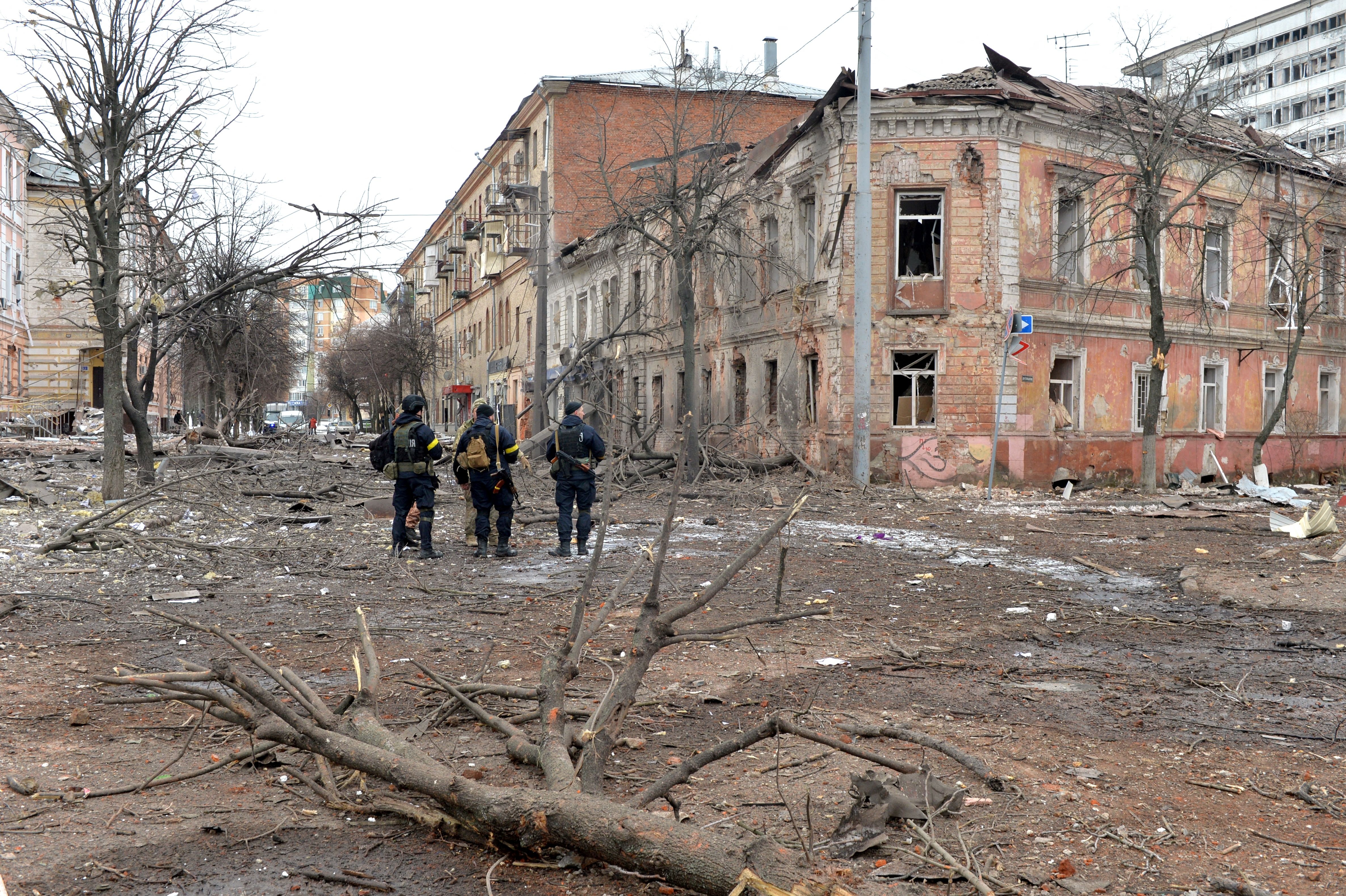 Ukrainian police officers patrol the bombed streets of Kharkiv.