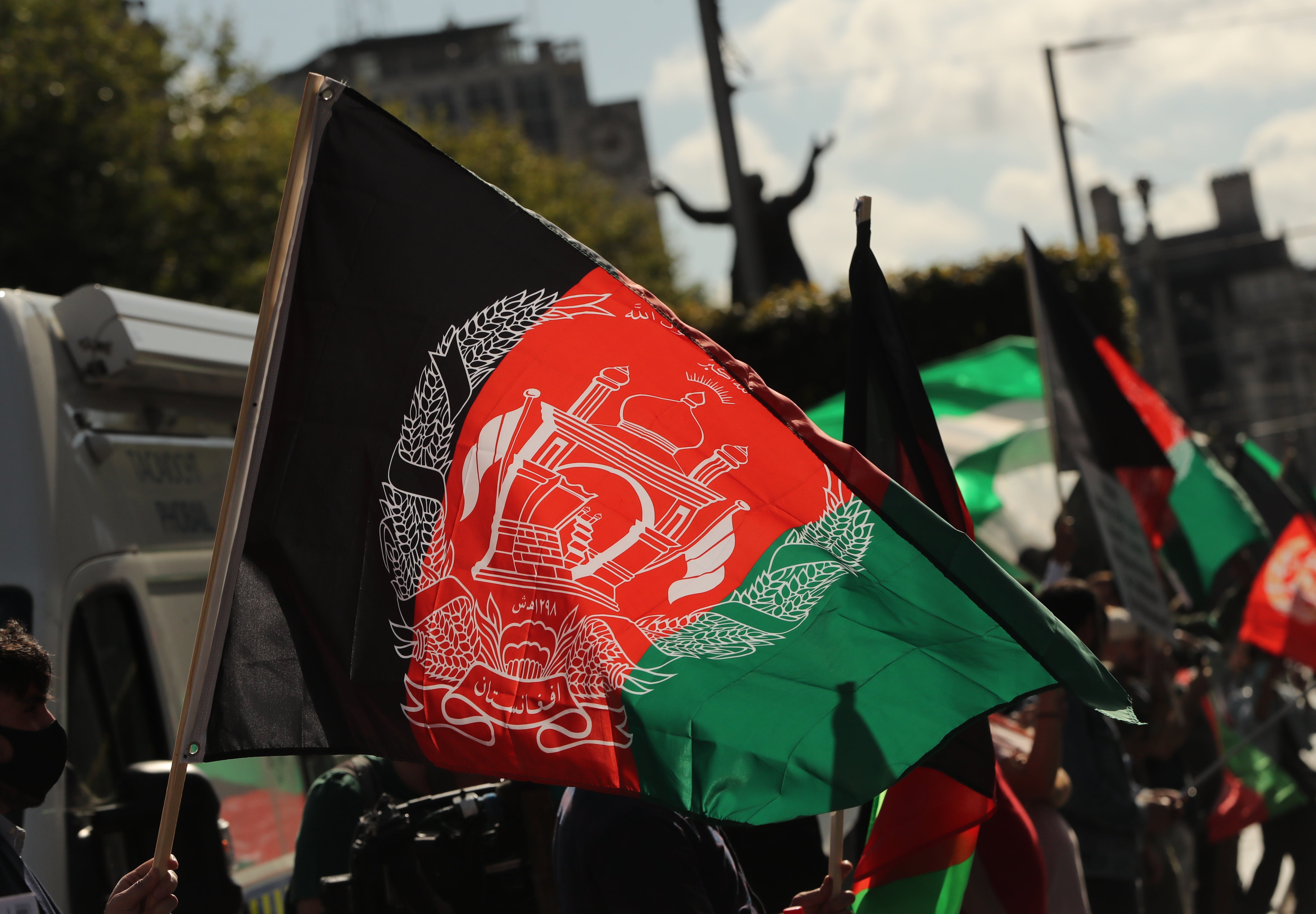 People waving Afghan flags (PA)