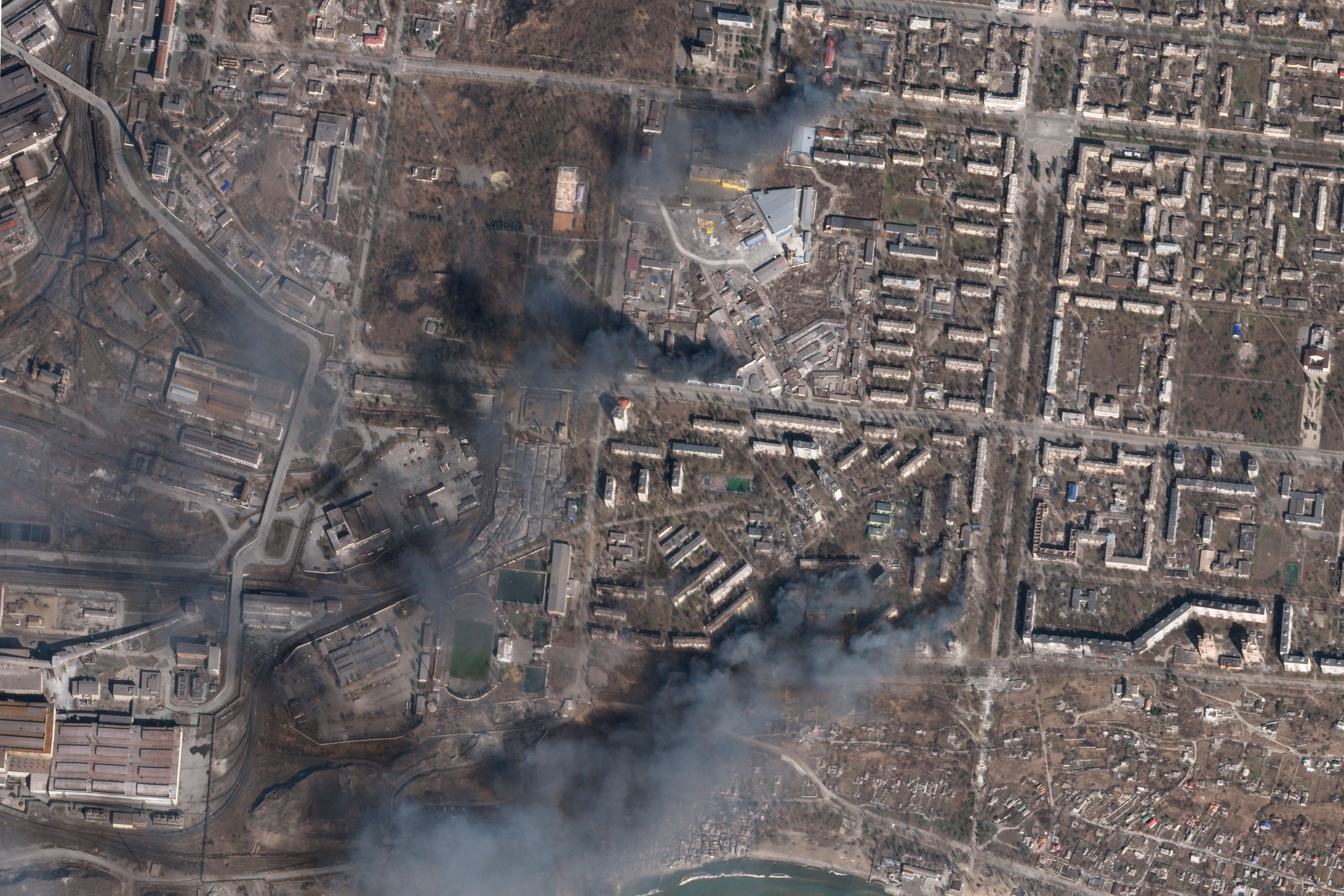 In this satellite photo, buildings burn after Russian strikes on a district of Mariupol